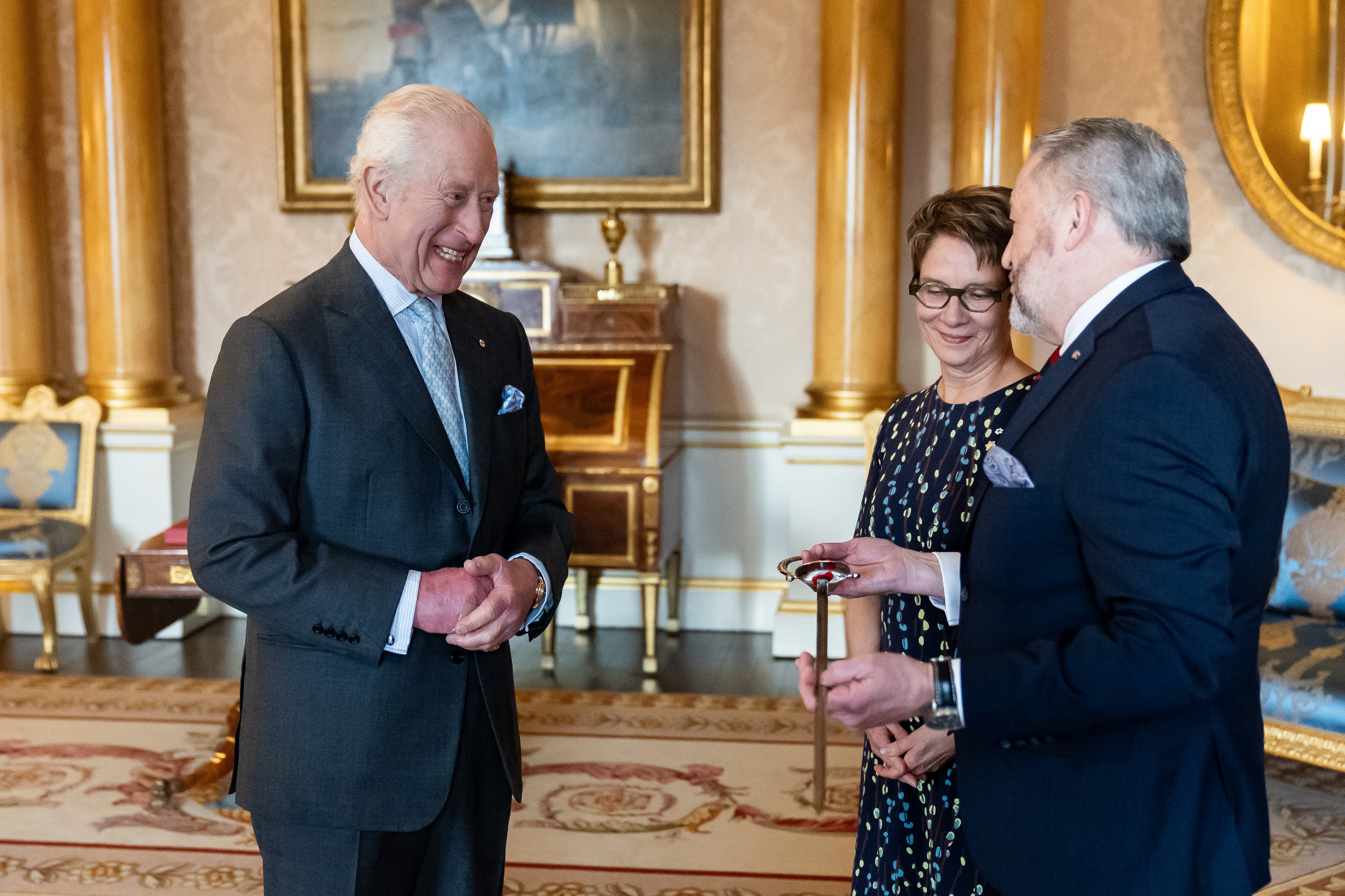 King Charles III bestows a new ceremonial sword to the Usher of the Black Rod of the Senate of Canada Gregory Peters with Speaker of the Senate of Canada Raymonde Gagne present