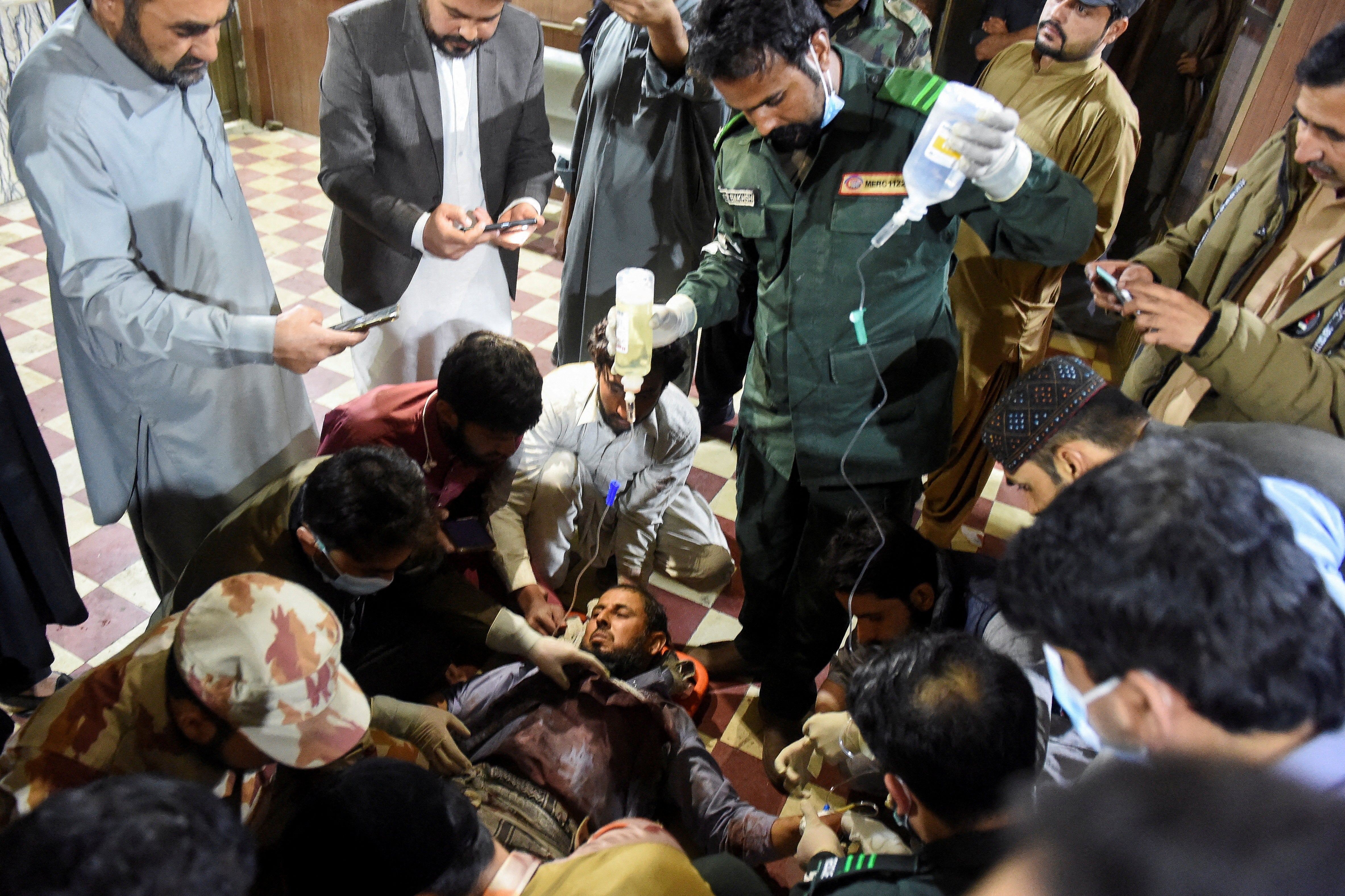 A passenger rescued from the train receives medical aid at the railway station in Mach