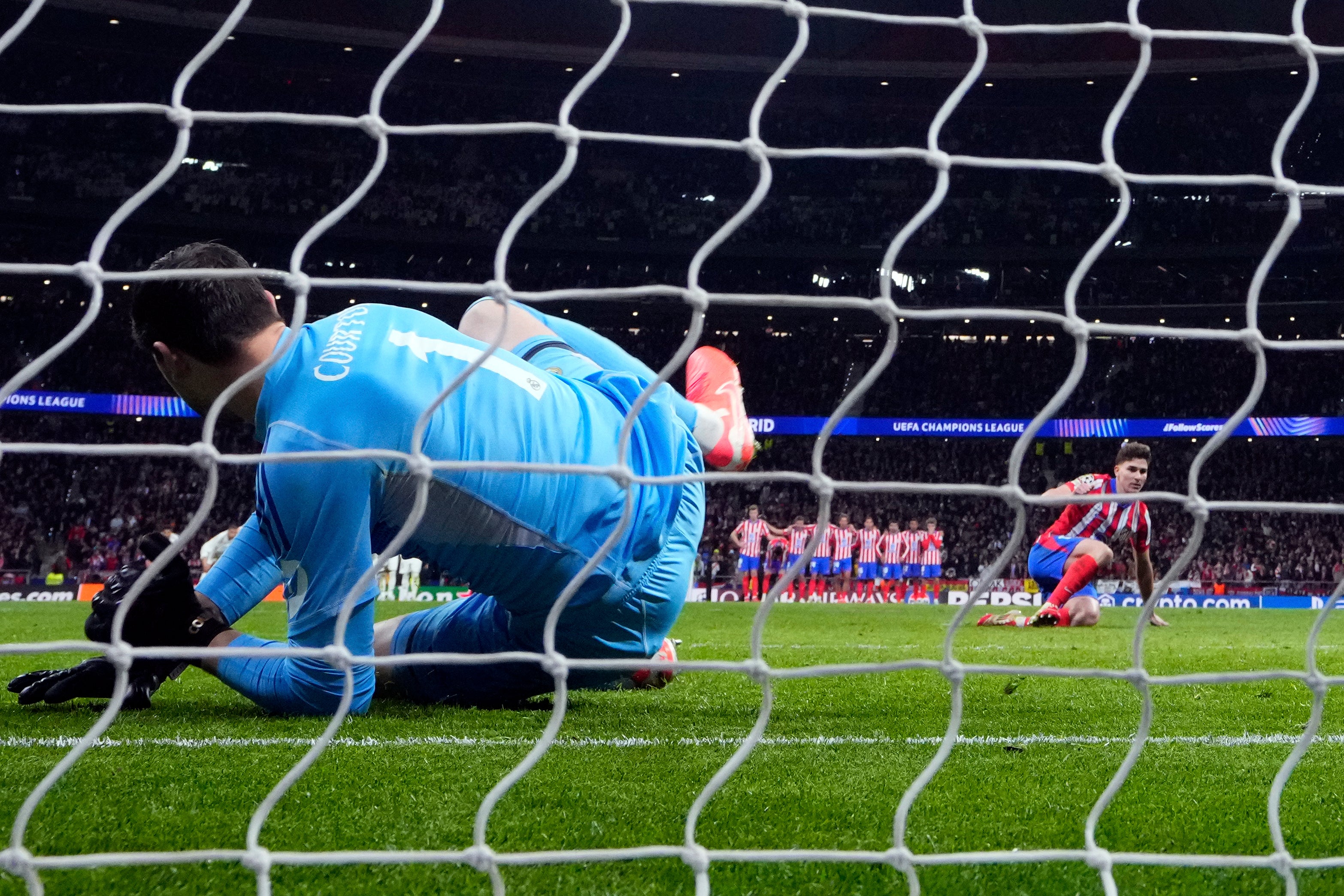 Thibaut Courtois dives as Julian Alvarez’s penalty goes in