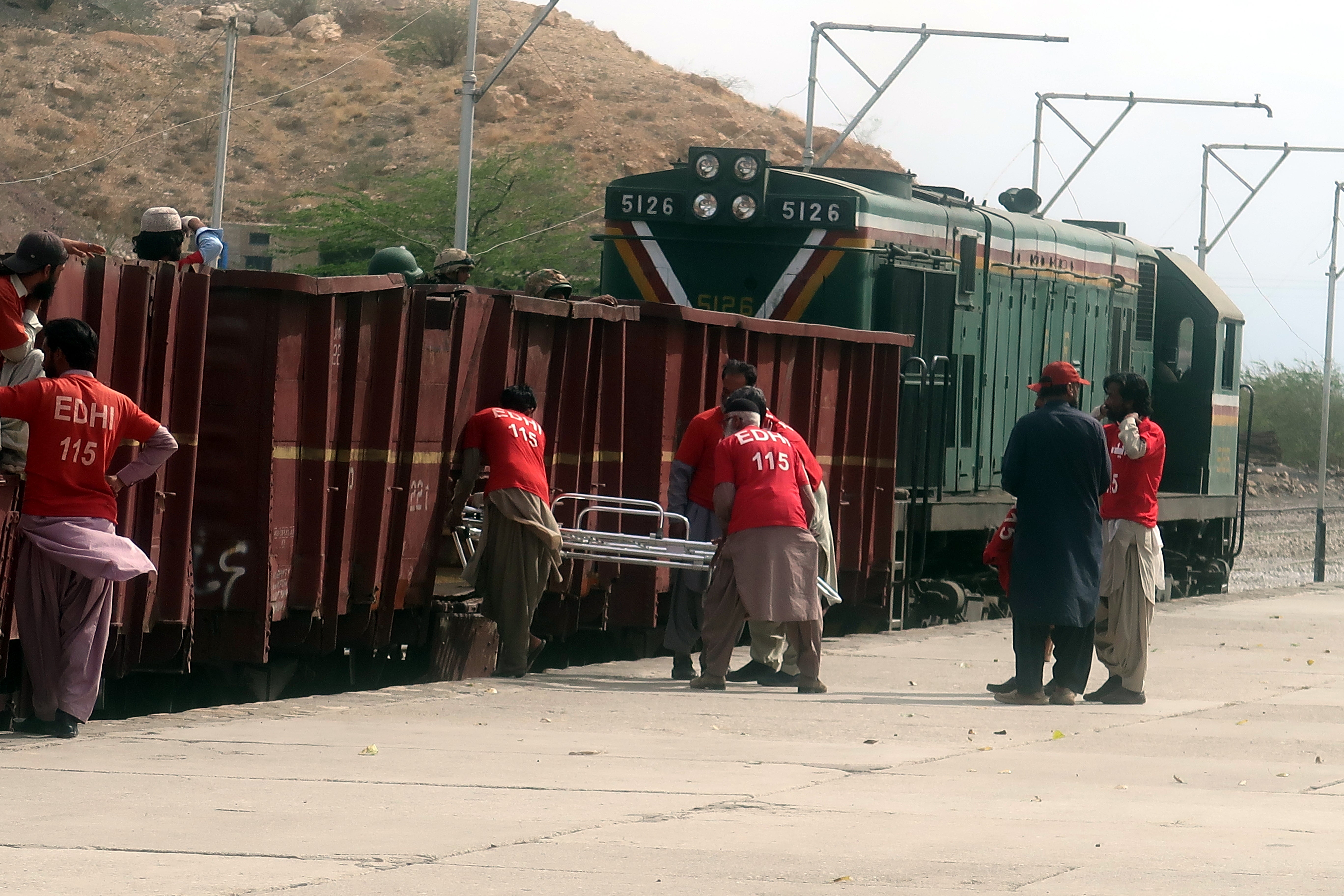 Rescue workers from the Edhi organization are preparing to participate in a rescue operation as they await boarding a special train following a militant attack on the Peshawar-bound Jaffar Express