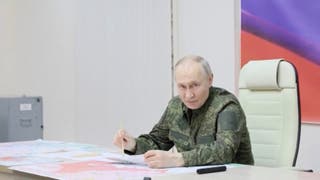 Russia's president Vladimir Putin addresses commanders as he visits a control centre in Kursk