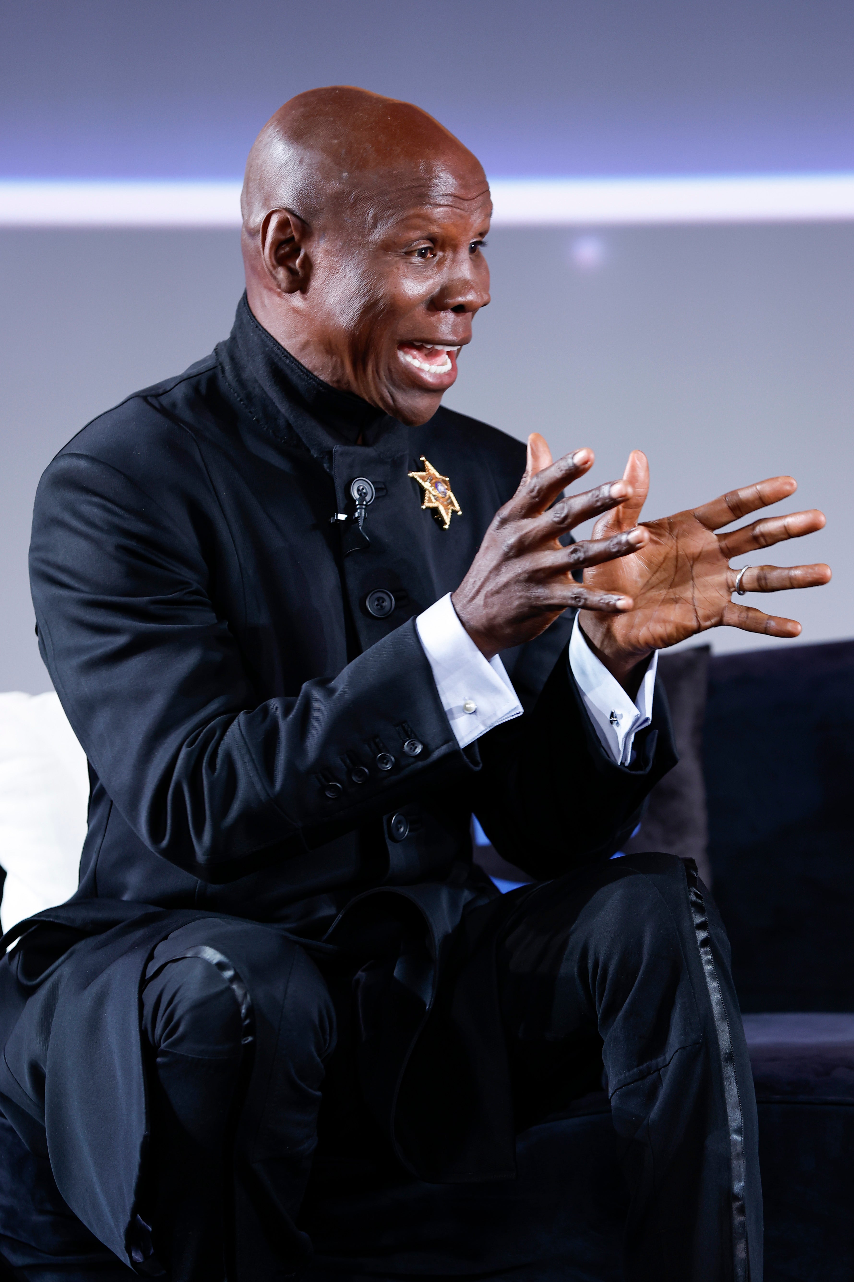 <p>Chris Eubank Sr speaking to boxing fans at a live event in 2024</p>