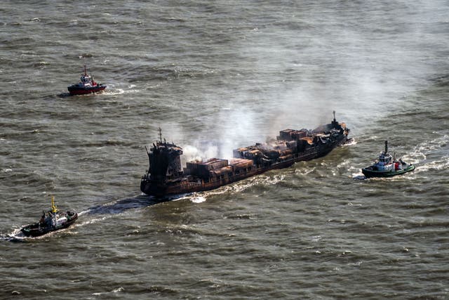 <p>Tug boats shadow the Solong container ship as it drifts in the Humber Estuary following a collision with the MV Stena Immaculate oil tanker (Danny Lawson/PA)</p>