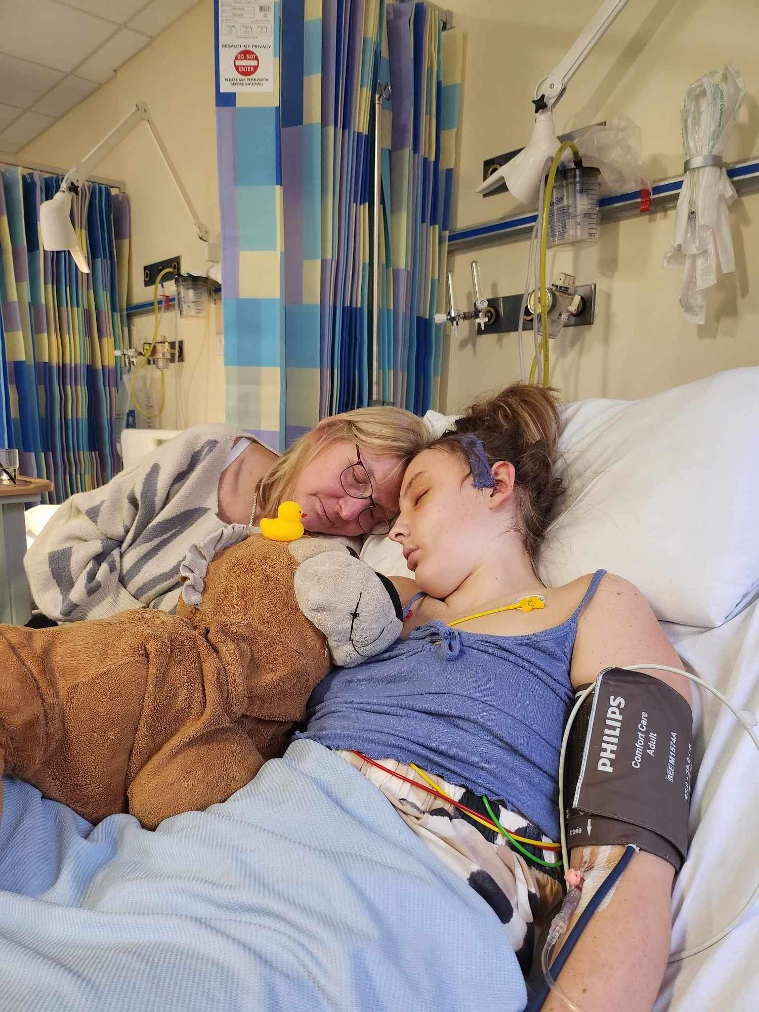 Kerr in a hospital bed with her mum, Ann, beside her