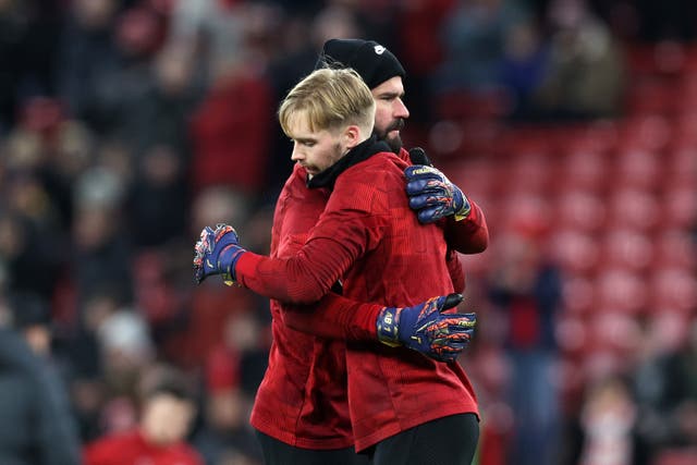 <p>Liverpool goalkeepers Alisson (facing right) and Caoimhin Kelleher</p>