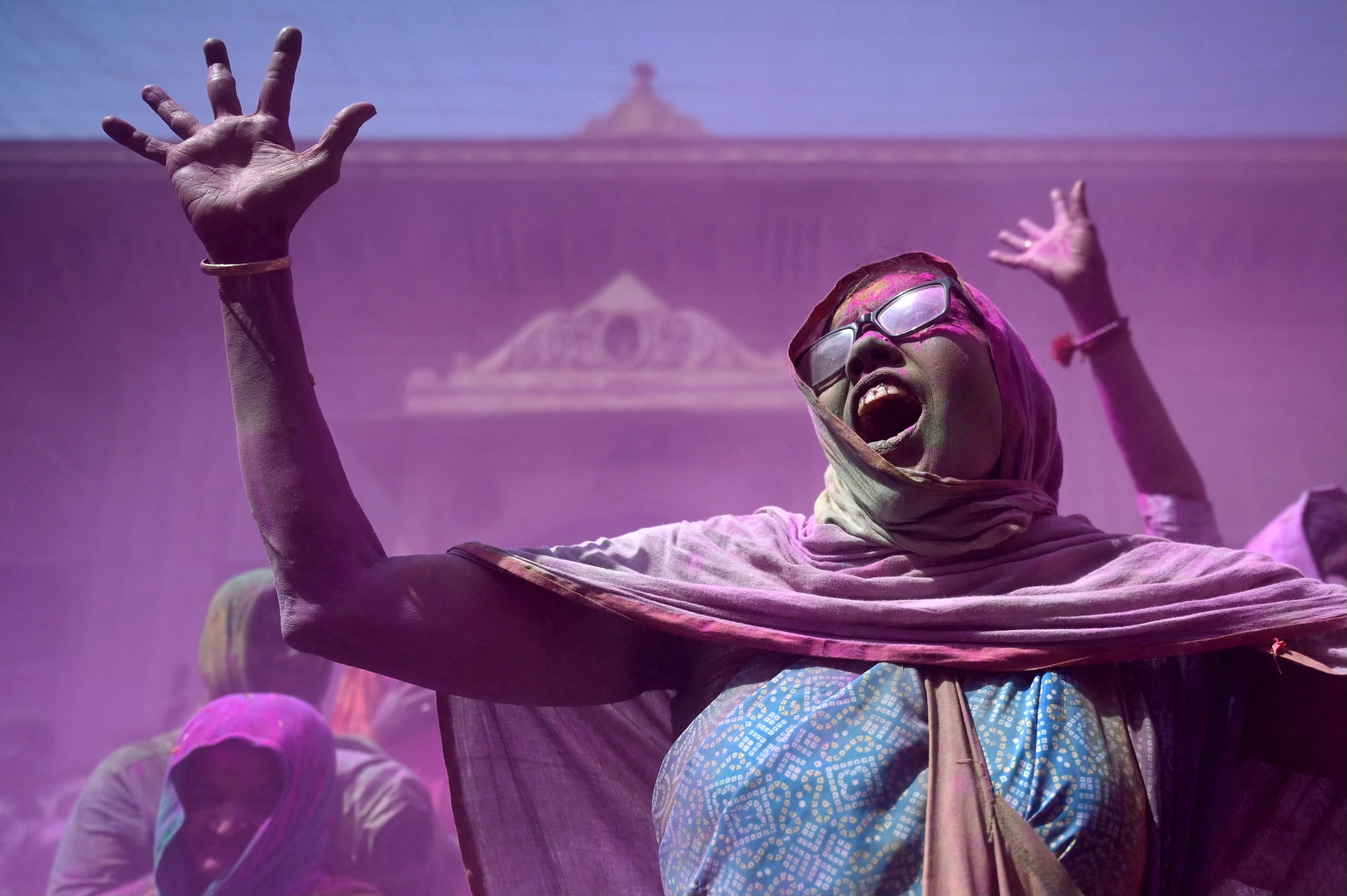 <p>Women smeared with colour powder celebrate Holi at a temple in Vrindavan, India</p>