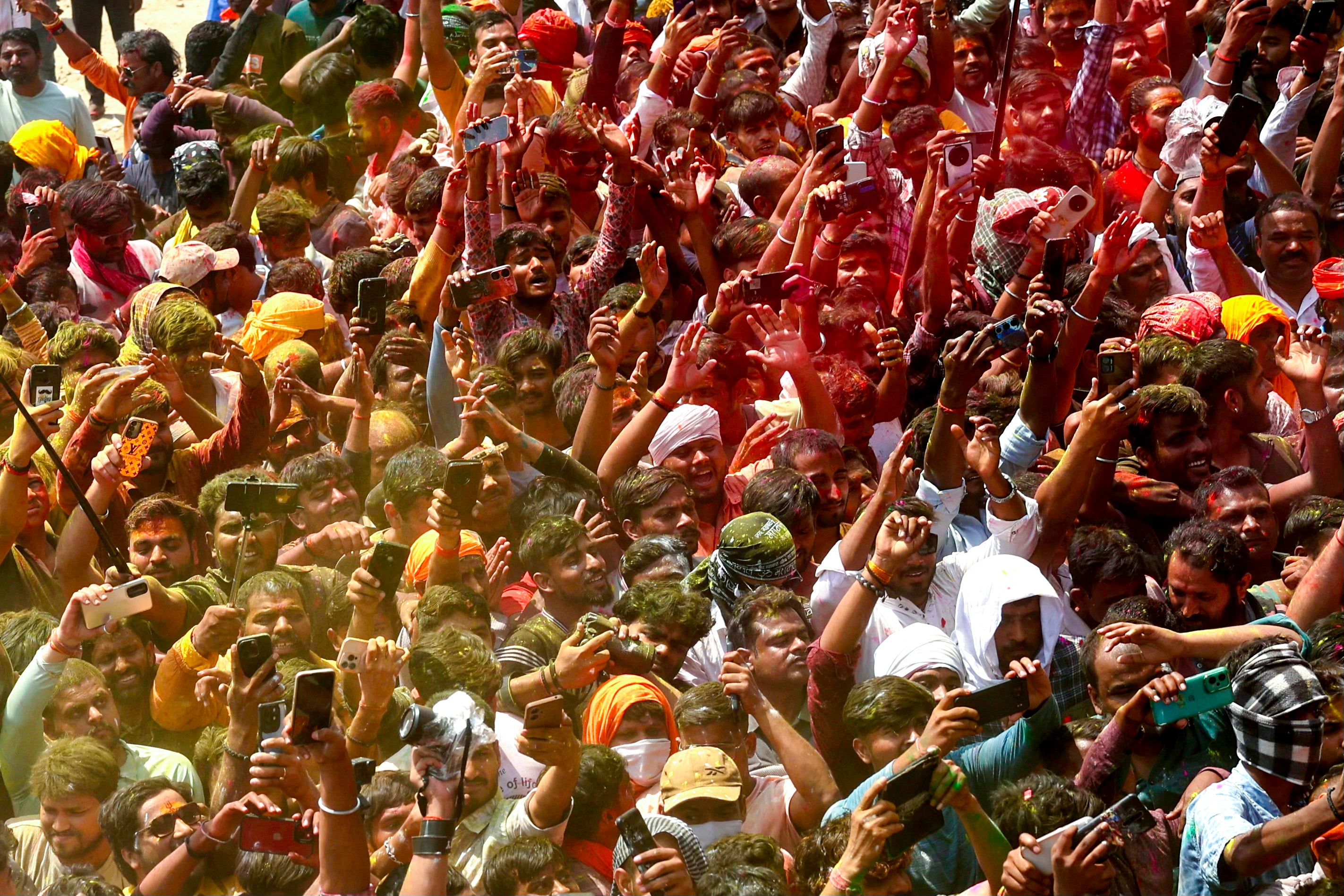 Hindu devotees gather to celebrate 'Masaan' or 'Bhasma' Holi along the banks of the Ganga river in the northern Varanasi city