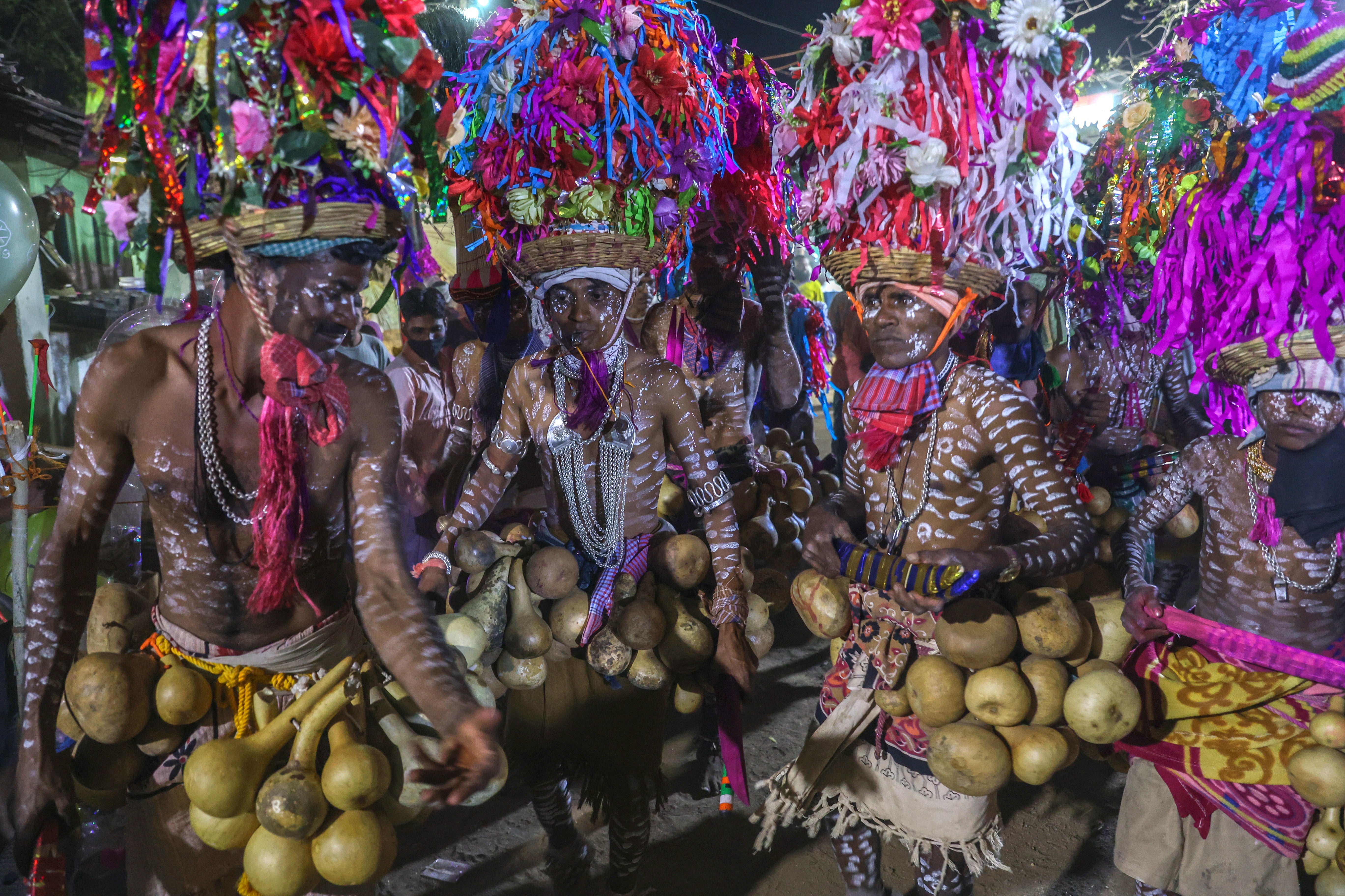 Indian tribals dance to traditional folk tunes as they celebrate Holi, also known as Rajwadi Holi, in Nandurbar in the western state of Maharashtra