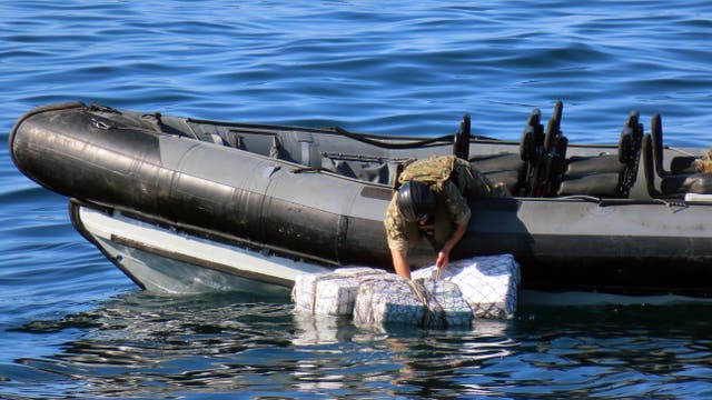 <p>Crew of HMS Lancaster recovering ditched bales of drugs </p>