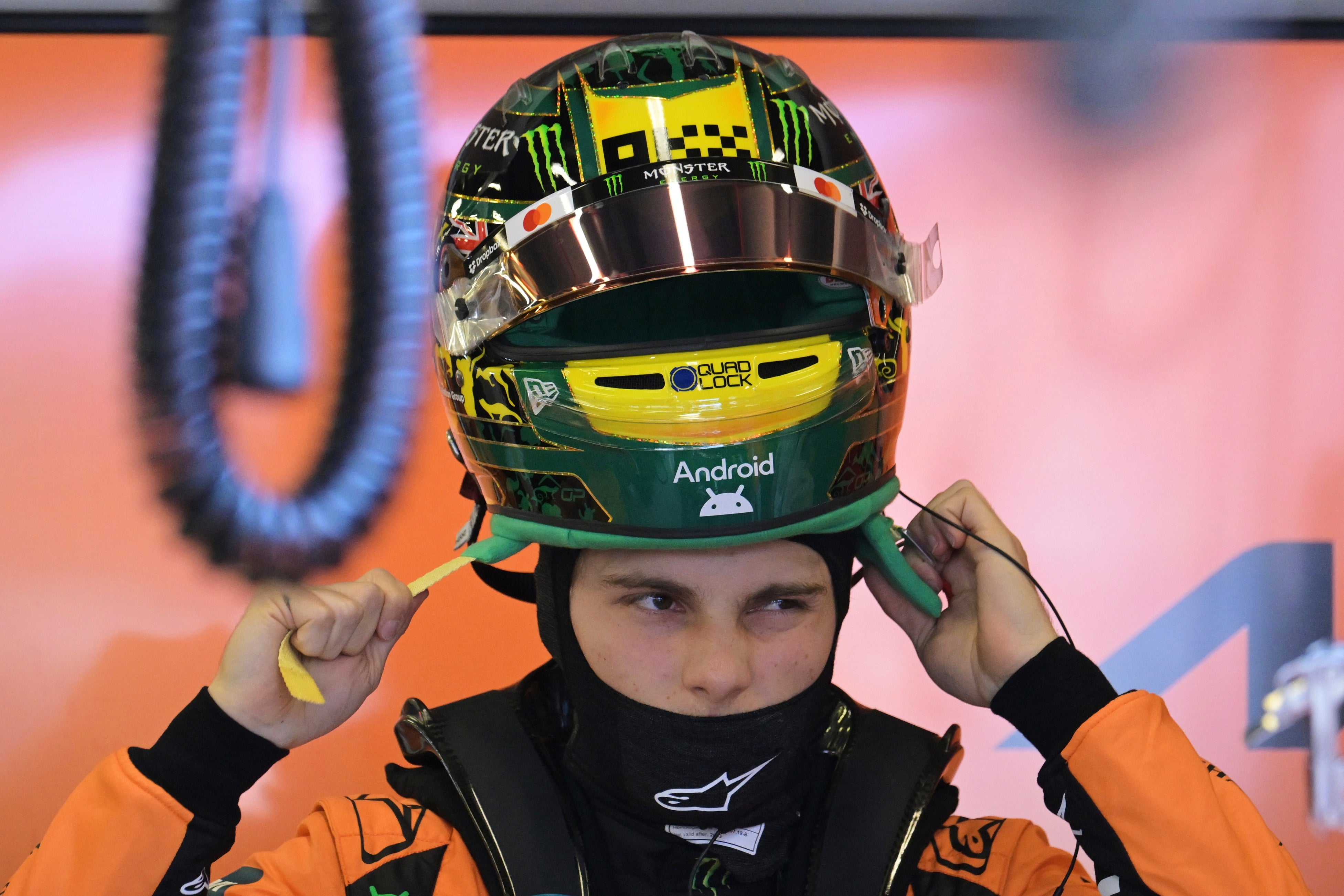 McLaren driver Oscar Piastri of Australia puts his helmet on during qualifying (Tracey Nearmy/Pool/AP)