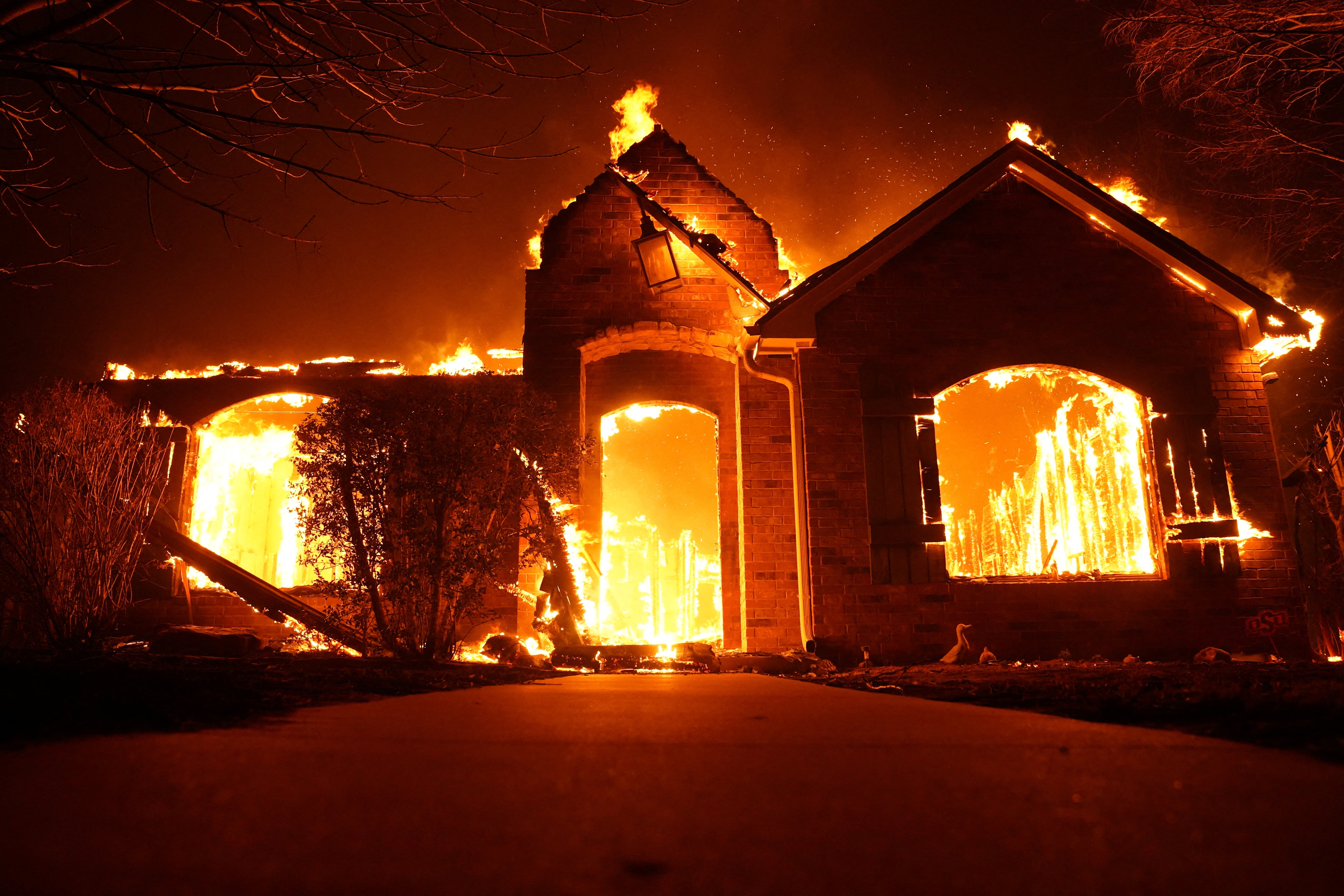 A blaze overtakes a home in Stillwater, Oklahoma on Friday as wildfires in the state destroy more than 200 homes