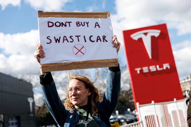 <p>A protest outside a Tesla dealership in Park Royal in March</p>
