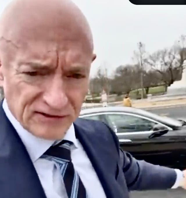 <p>Arizona Senator Mark Kelly gestures toward his Tesla, which he got rid of Friday after Elon Must called him a 'traitor' for visiting wounded soldiers in Ukraine, and because Musk is taking a wrecking  ball to the nation, the lawmaker complained</p>