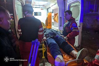 Medical workers transport a wounded resident on the site of a Russian rocket strike in Kryvyi Rih