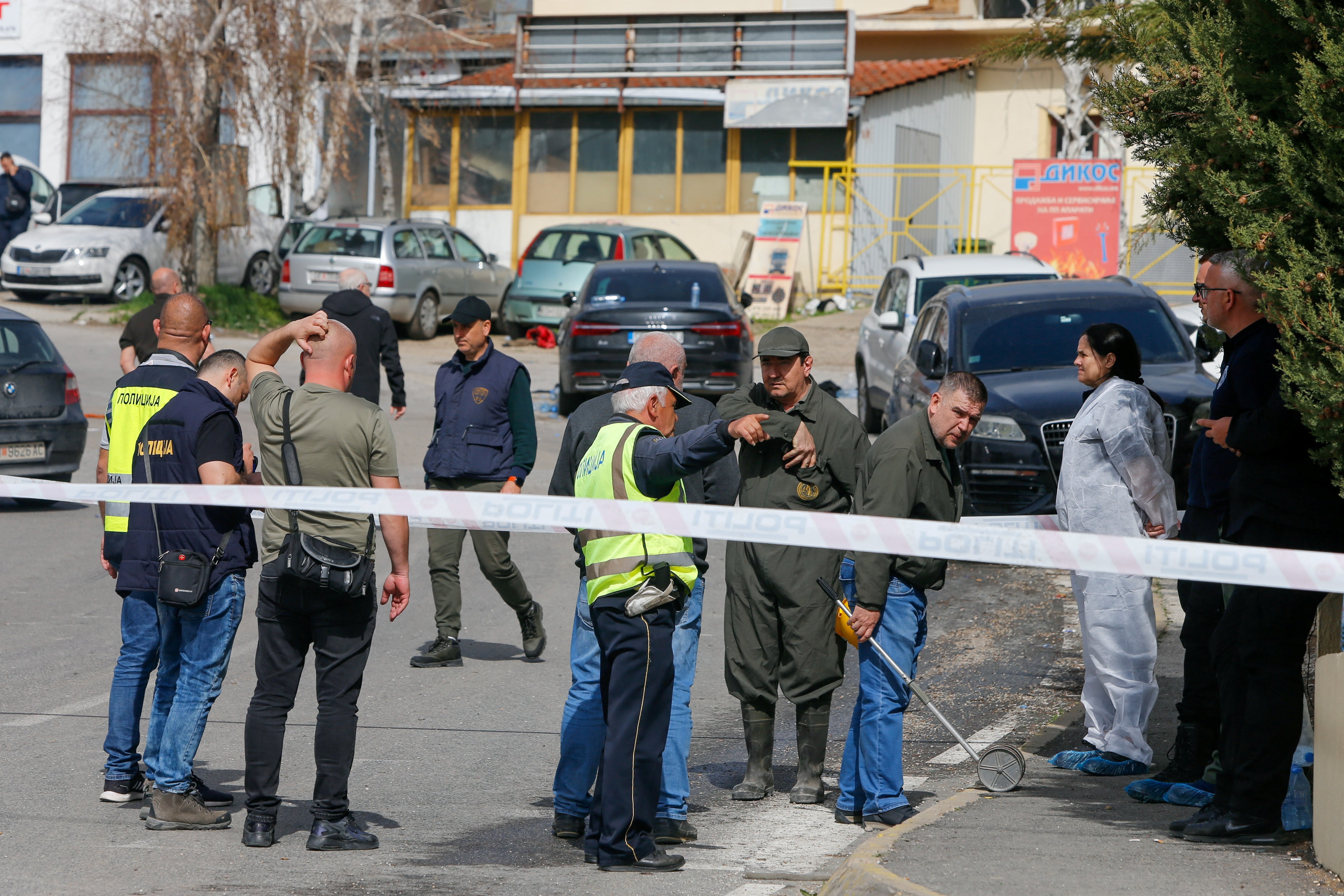 Emergency responders stand outside the night club in response to the blaze