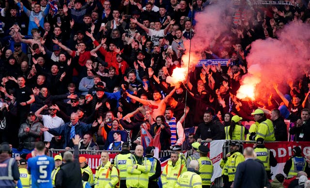Celtic fans restrained by police after Rangers player sprays water on ...