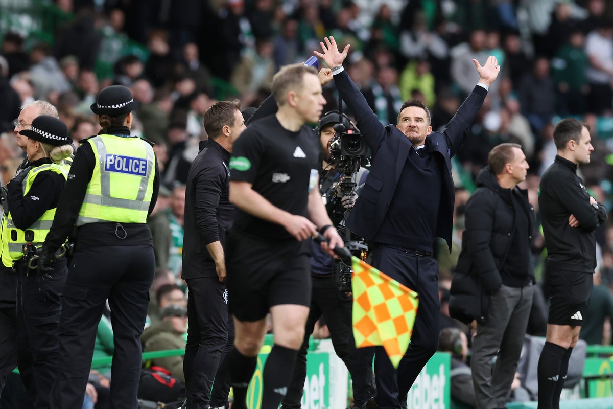 Celtic fans restrained by police after Rangers player sprays water on them in fiery Old Firm clash Celtic fans restrained by police after Rangers player sprays water on them in fiery Old Firm clash