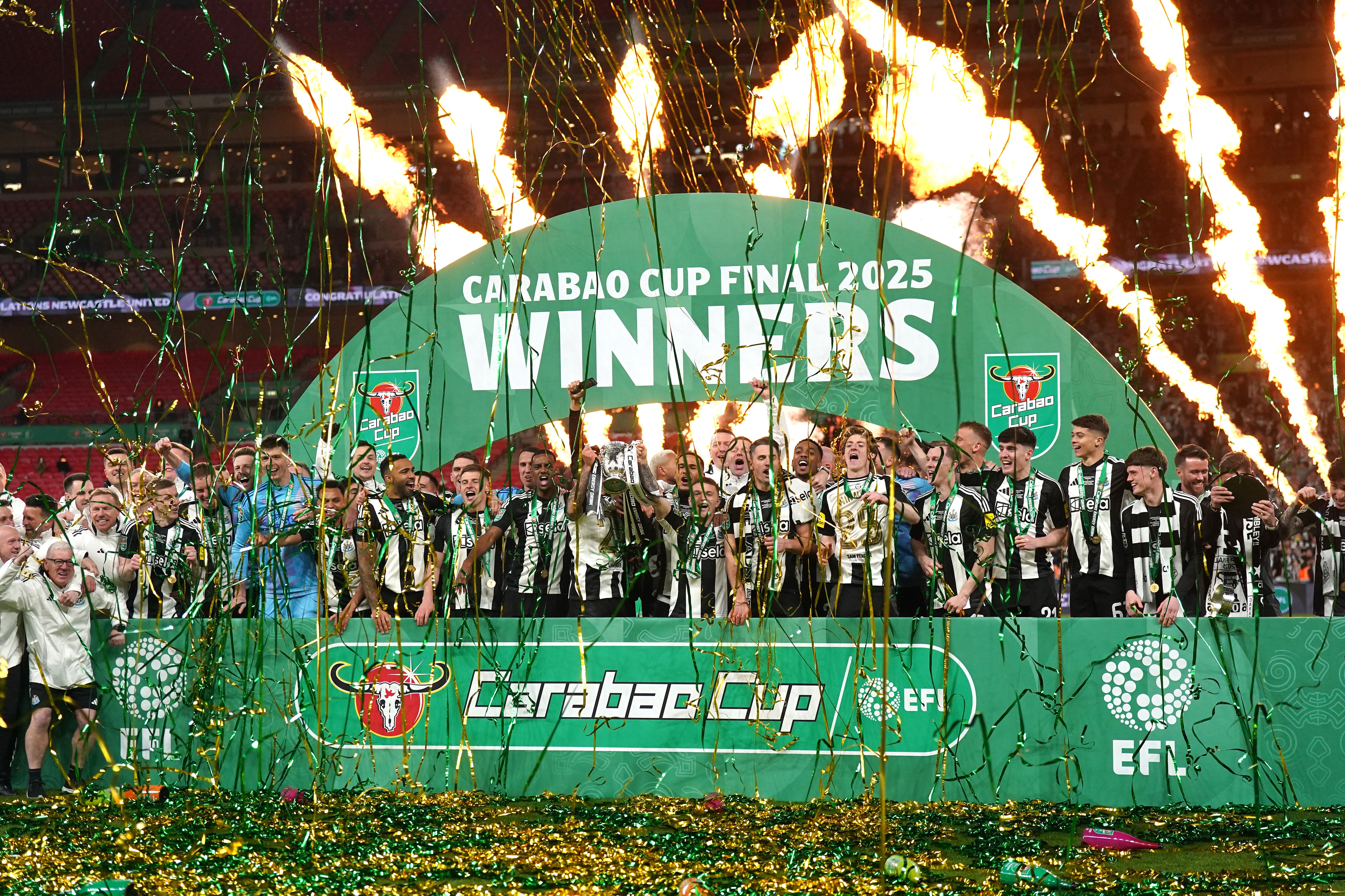 Newcastle United’s Bruno Guimaraes and Kieran Trippier lift the Carabao Cup trophy