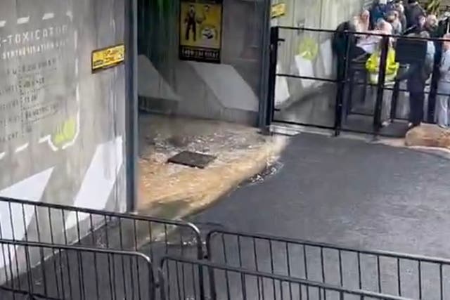 <p>Video footage shows brown liquid flooding the ride’s entrance from an overflowing drain</p>