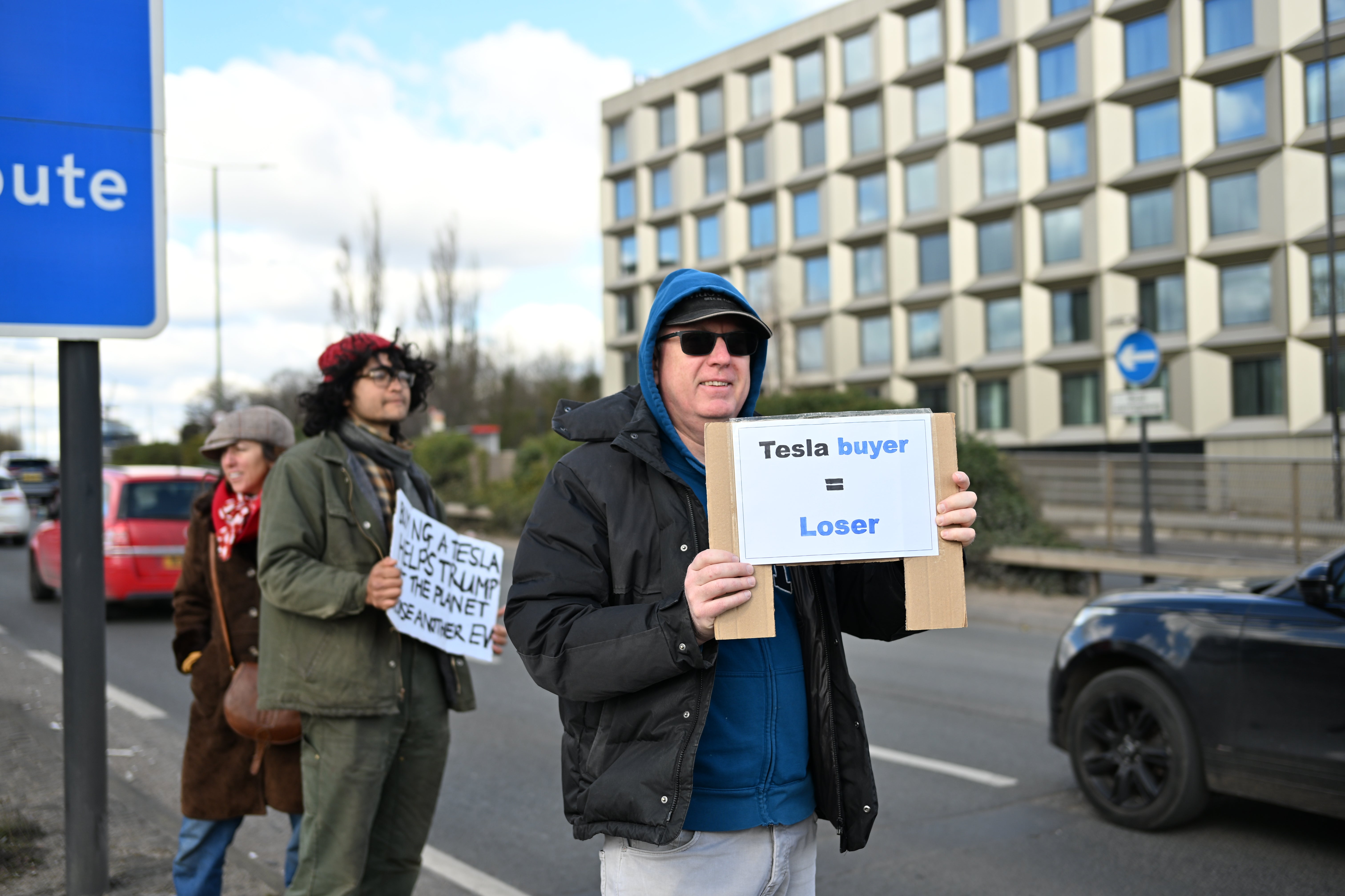 'Tesla Buyer = Loser' calls a placard in protest against Elvan Mask in West London at the weekend