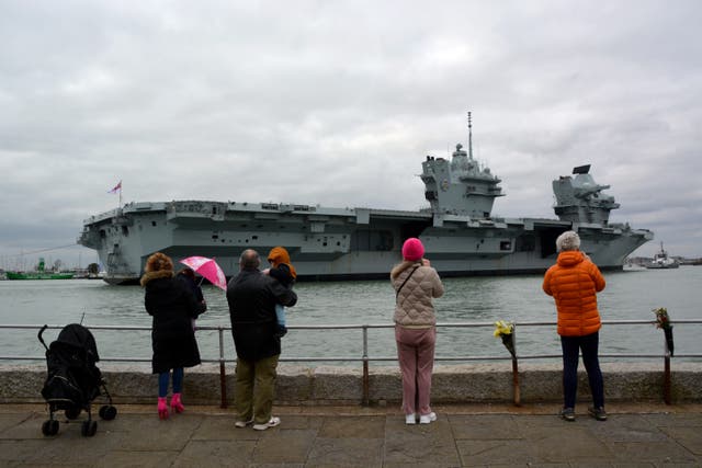 Members of the public watch as HMS Prince of Wales returns to Portsmouth Naval Base (Ben Mitchell/PA)