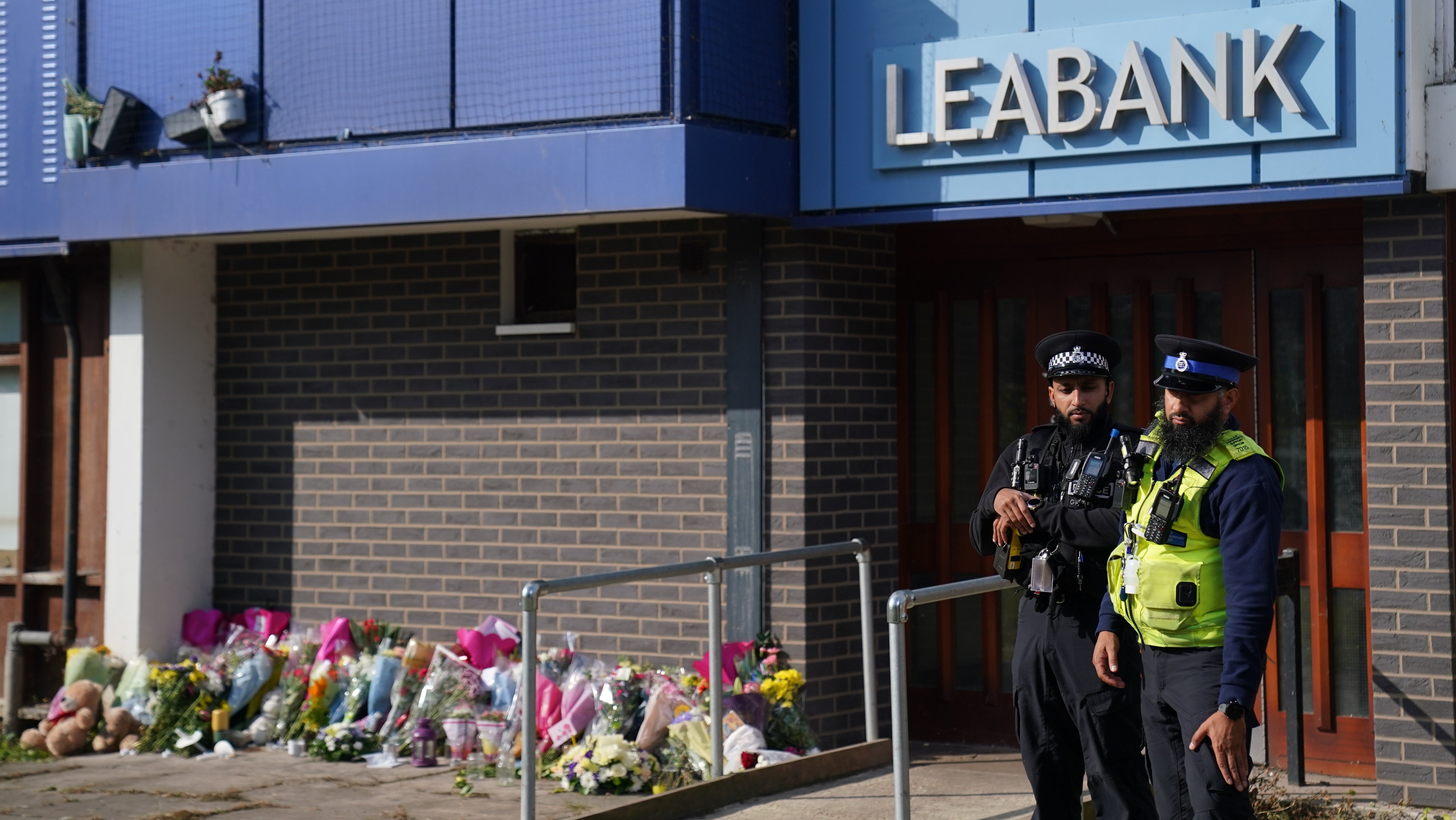 Flowers at the block of flats in Luton where Prosper shot his mother, brother and sister