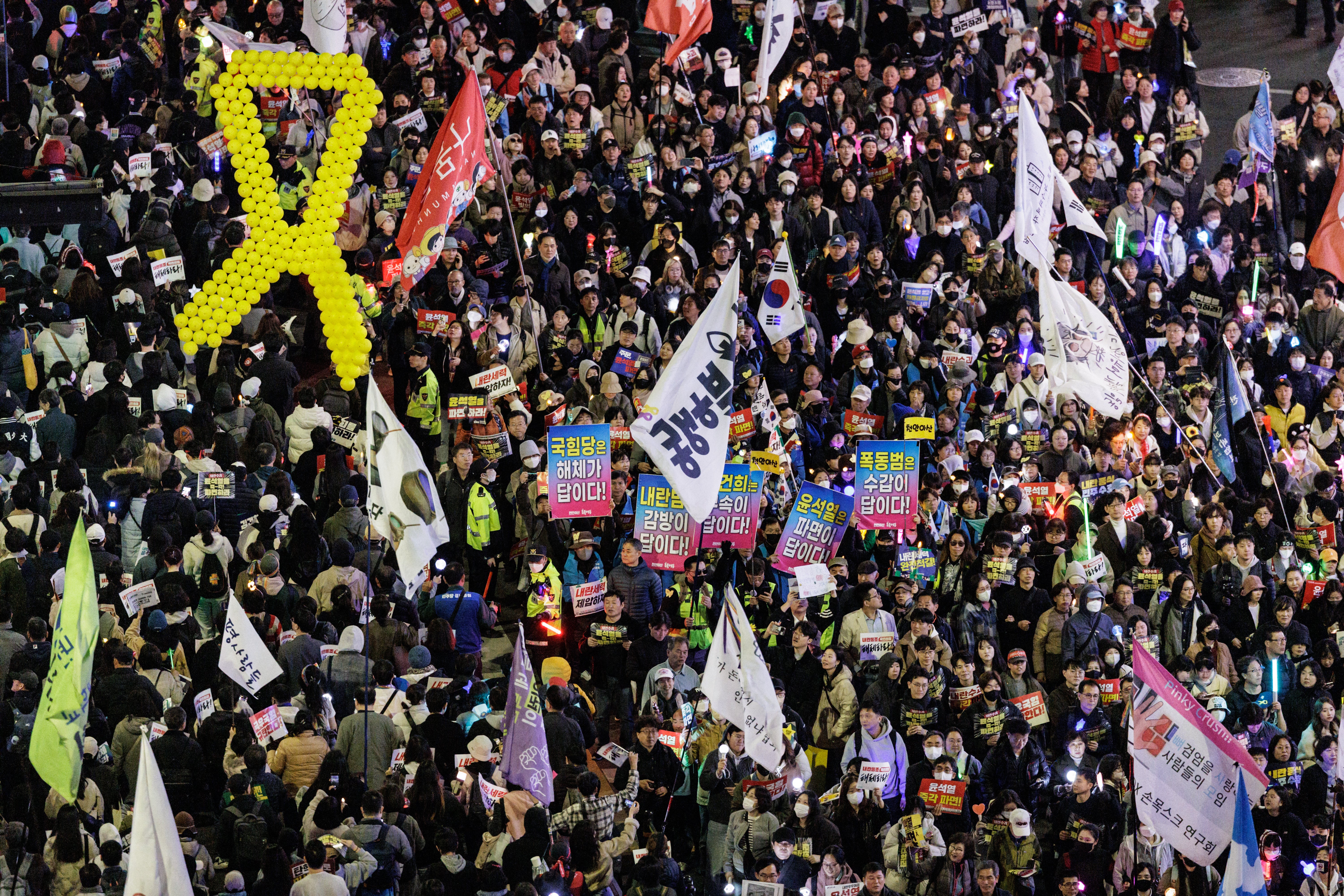 Protesters march through the streets in a demonstration against impeached South Korean president Yoon Suk Yeol