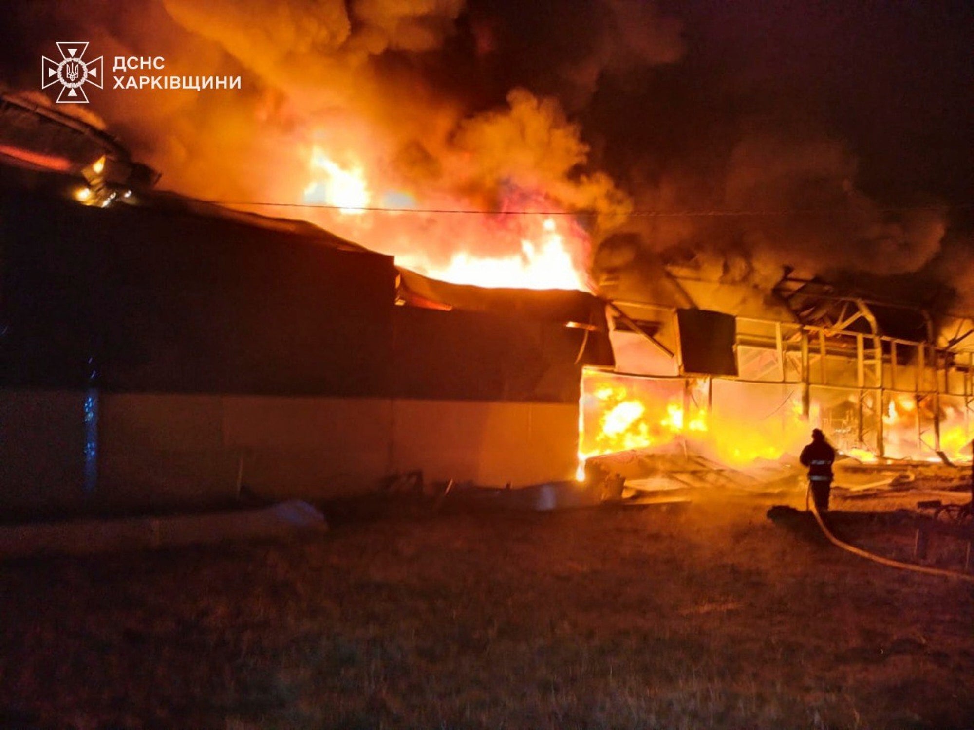 Firefighters put out the fire at a storehouse following a Russian attack in Chuhuiv, Kharkiv region, Ukraine