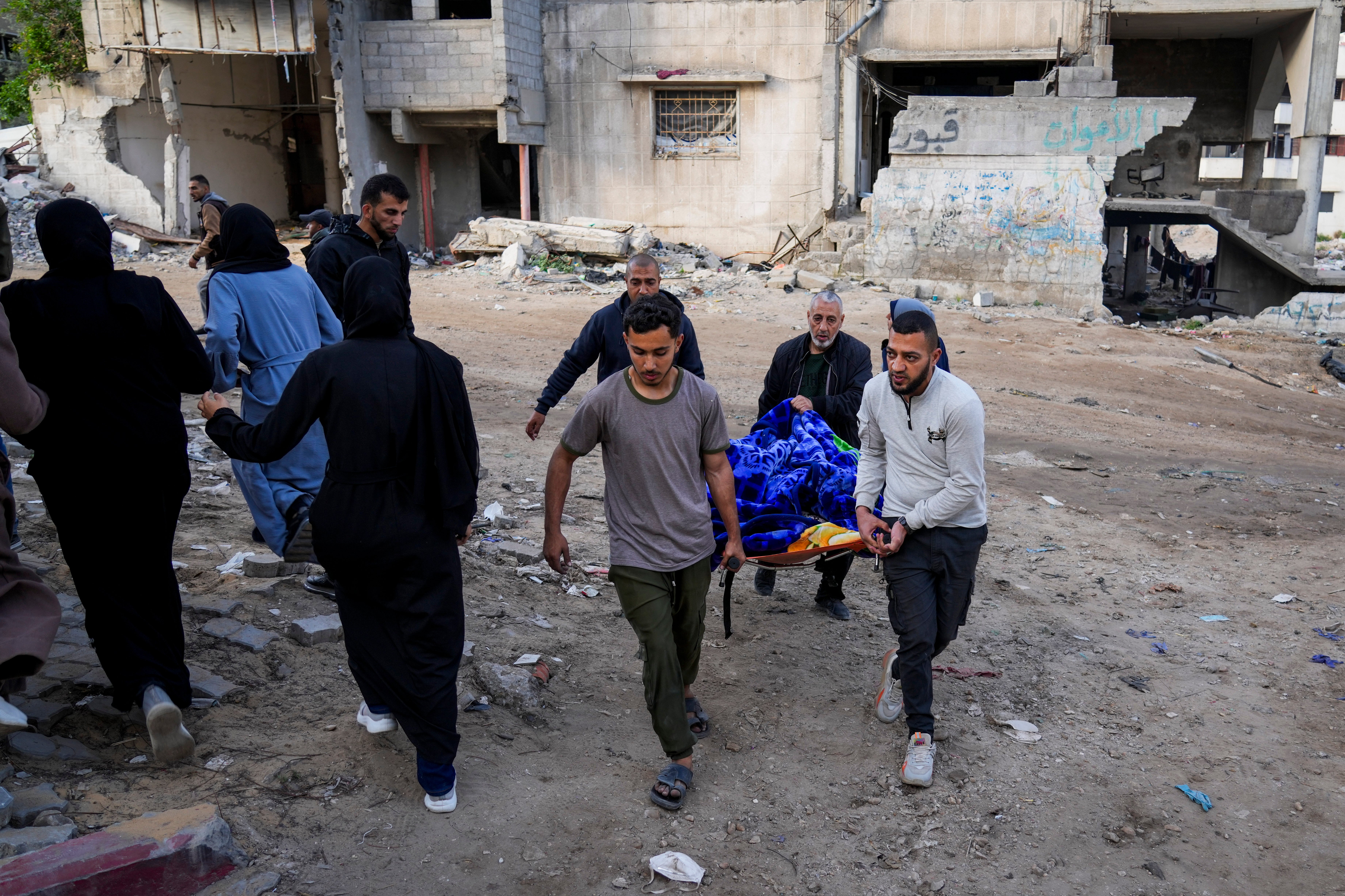 The body of a Palestinian killed in an Israeli army airstrikes is brought to Shifa Hospital in Gaza City