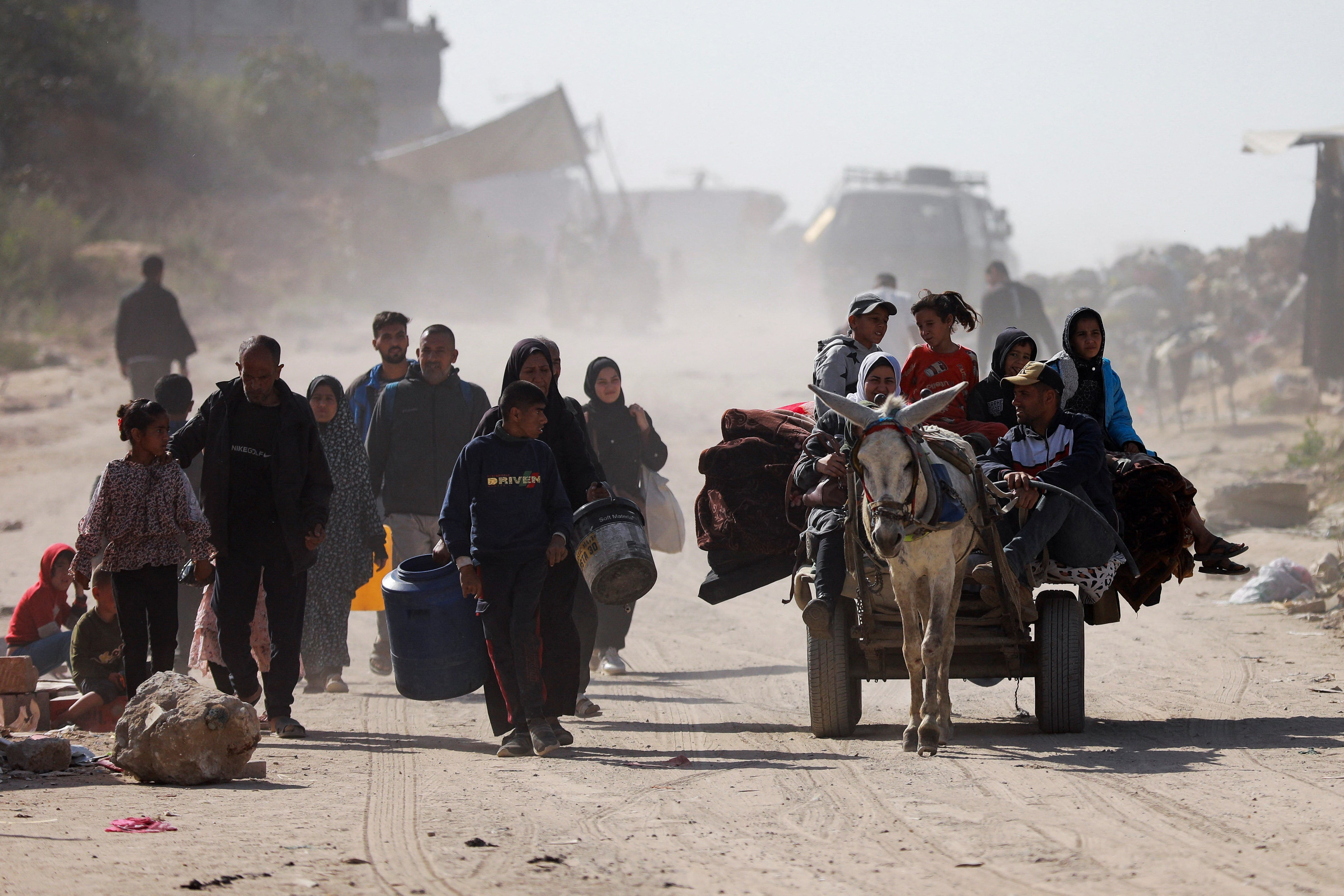 Palestinians make their way to flee their homes following heavy Israeli strikes, in Beit Lahiya in the northern Gaza Strip on March 18