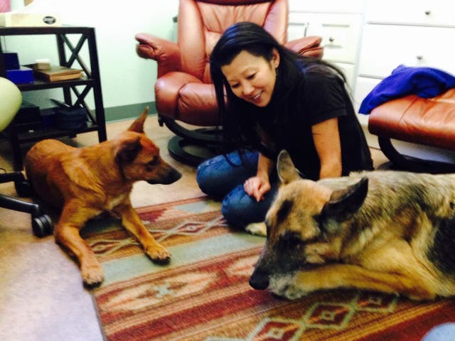 <p>Betsy Arakawa in an undated photo with two of her dogs</p>
