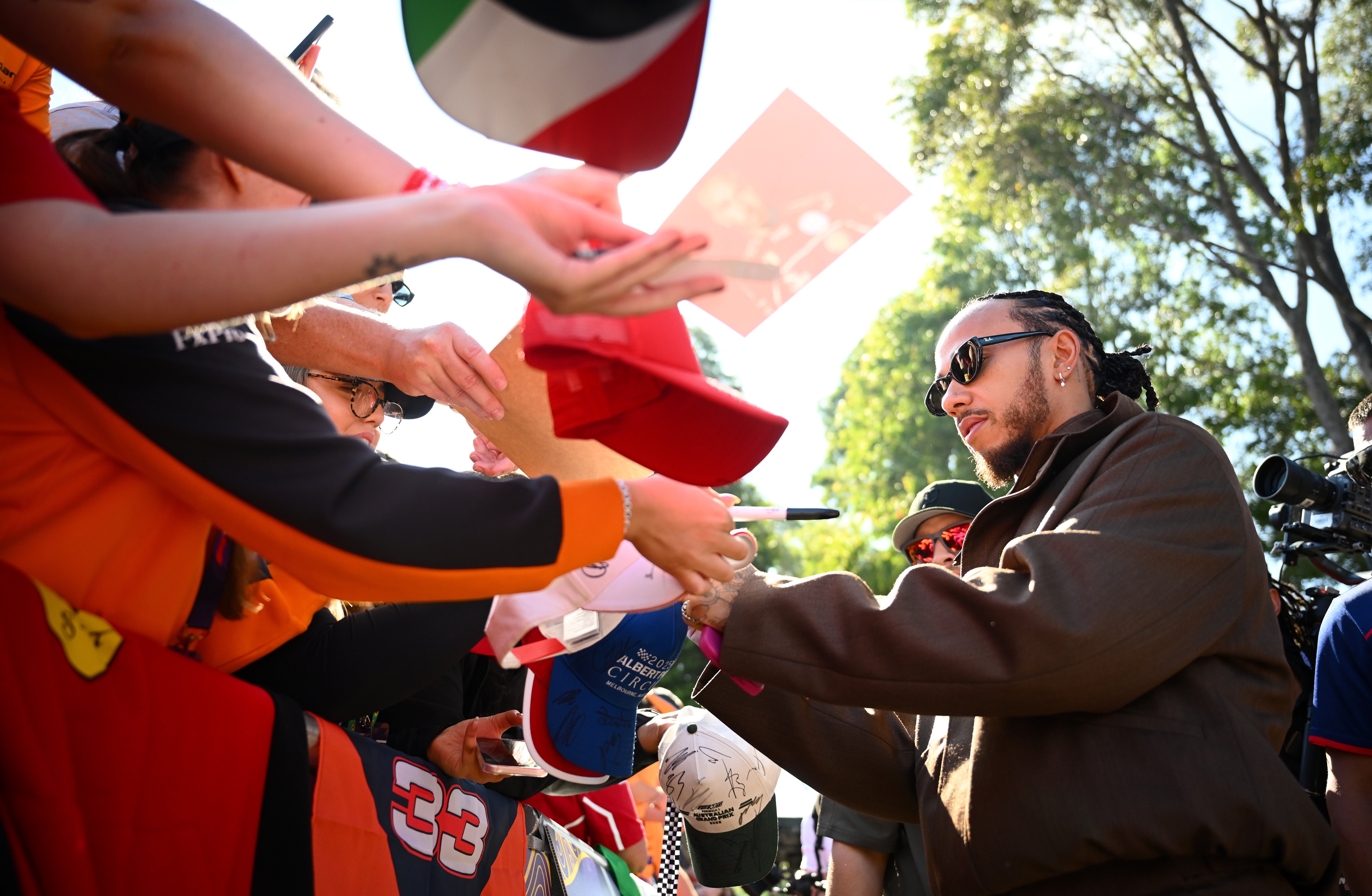 Lewis Hamilton signs autograph for fans on the ‘Melbourne Walk’ at Albert Park