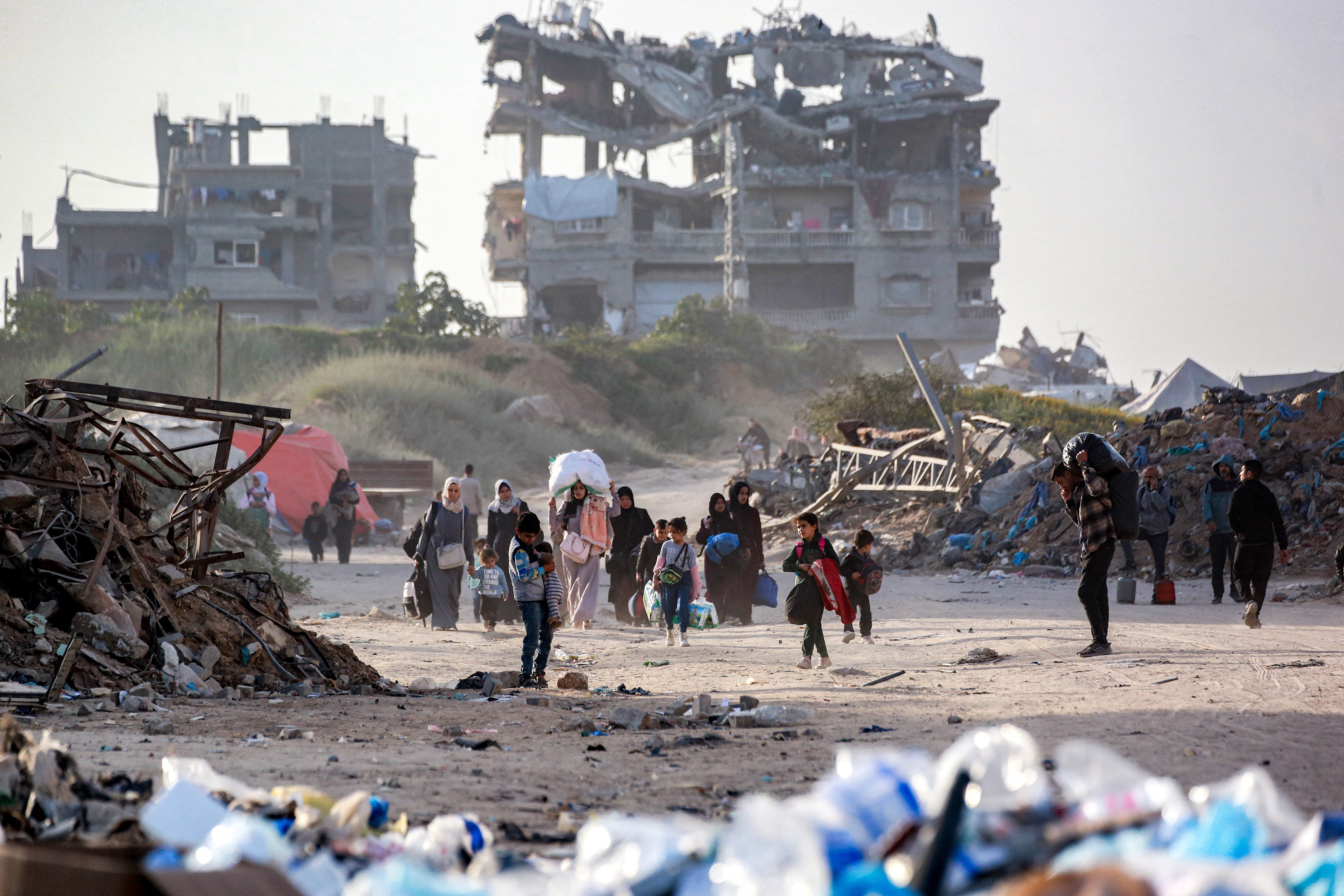 People displaced by conflict and fleeing from Beit Hanoun in the northern Gaza Stri