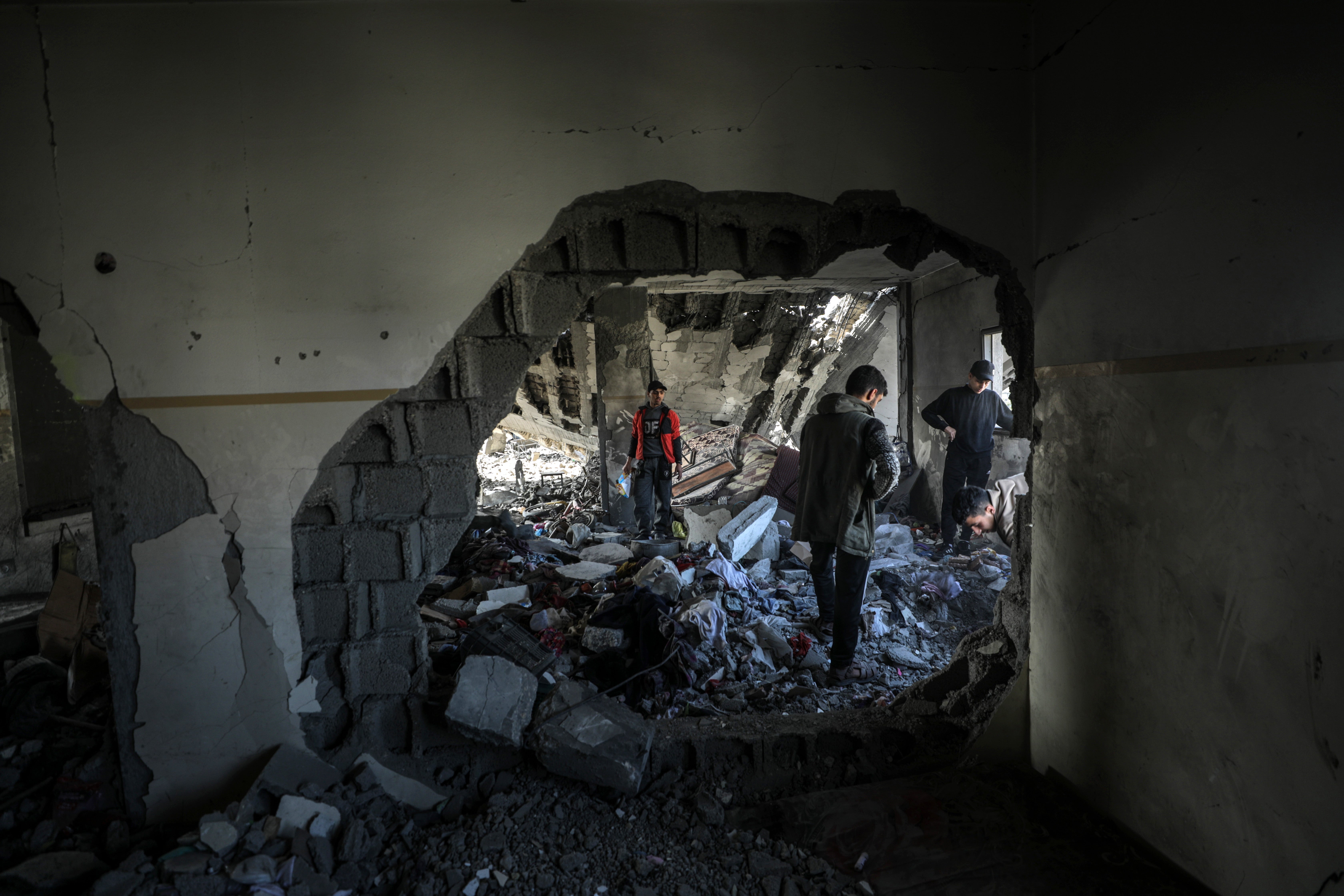 Palestinians inspect a destroyed area of Al Tabien school on Tuesday morning following Israeli airstrikes in Gaza City