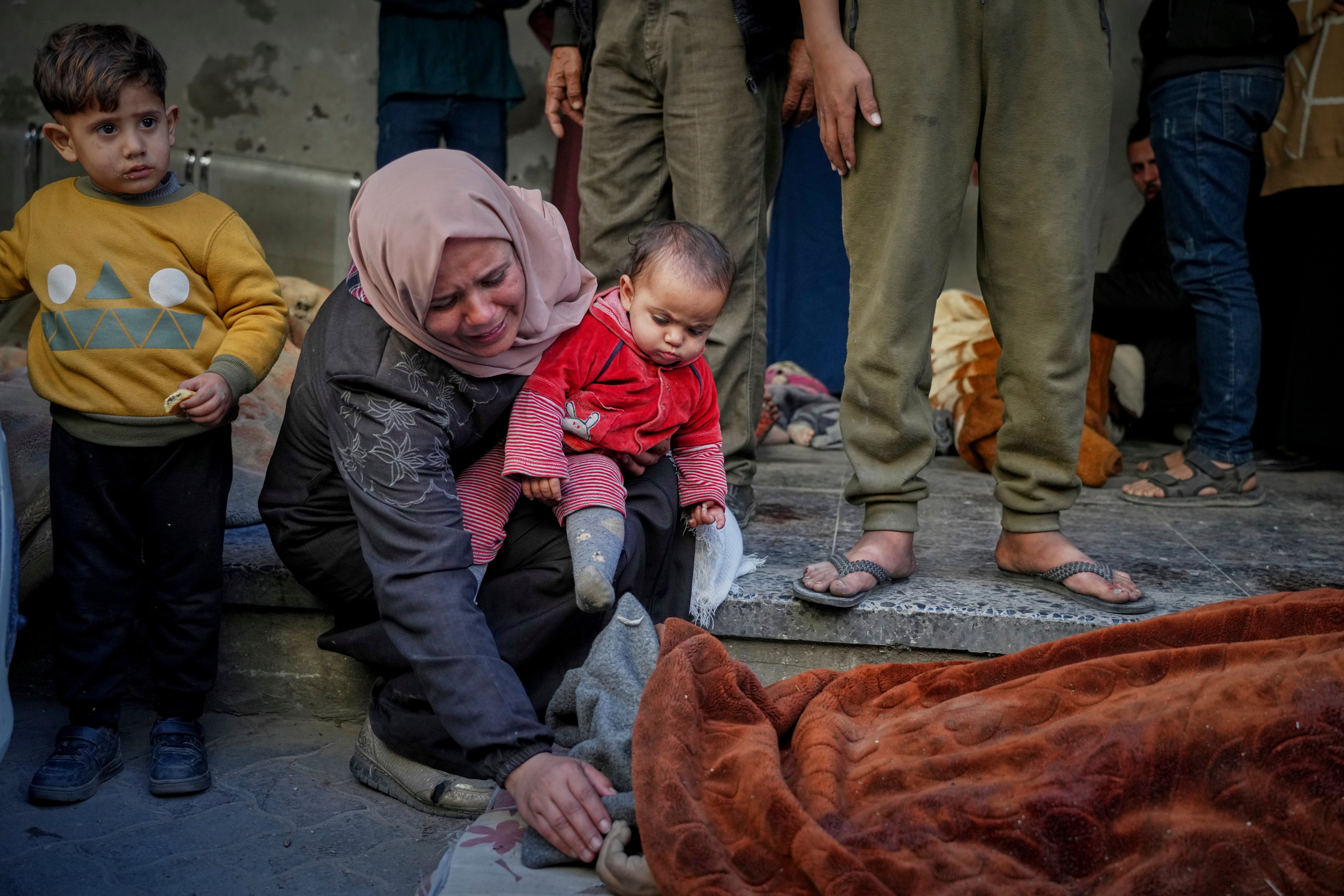 A woman mourns as she identifies a body in the Al-Ahli hospital