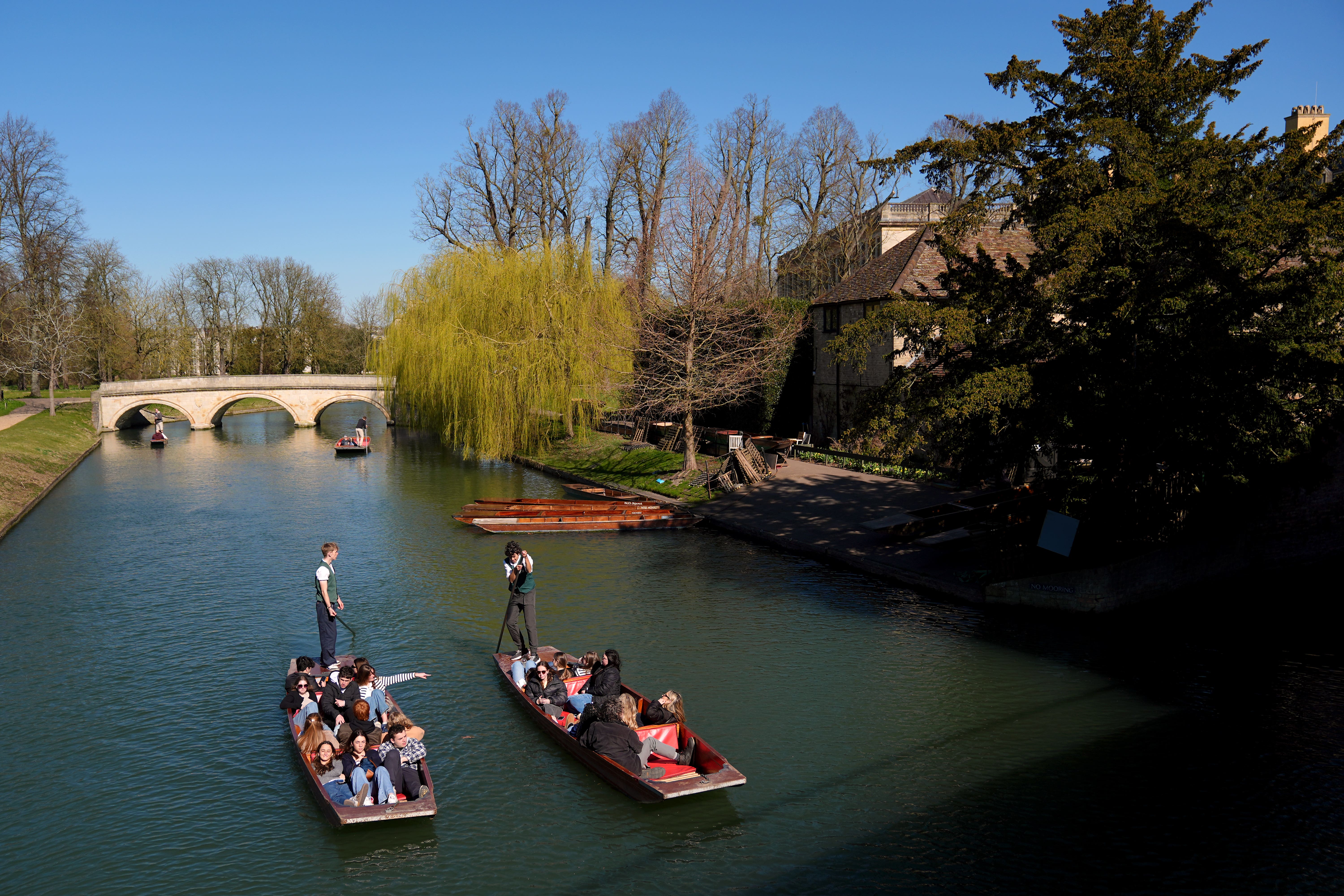 People enjoy the sunshine as they punt along the River Cam in Cambridge (Joe Giddens/PA)