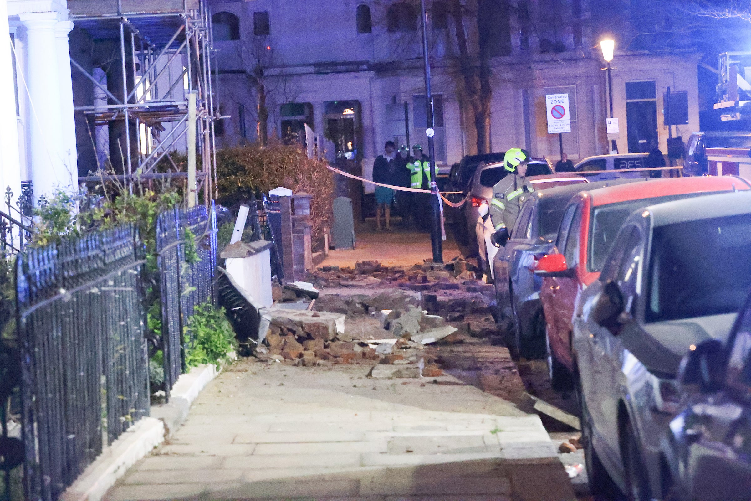 Rubble could be seen scattered across the ground and front gardens of the homes as two fire engines and dozens of firefighters rushed to the scene