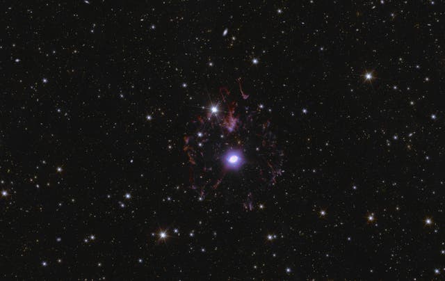 <p>The Cat’s Eye Nebula takes centre stage in a sparkling sea of stars and galaxies</p>