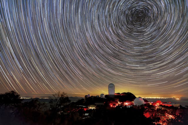 <p>This image provided by NSF’s NOIRLab shows the trails of stars above Kitt Peak National Observatory, where a telescope is mapping the universe to study a mysterious force called dark energy</p>