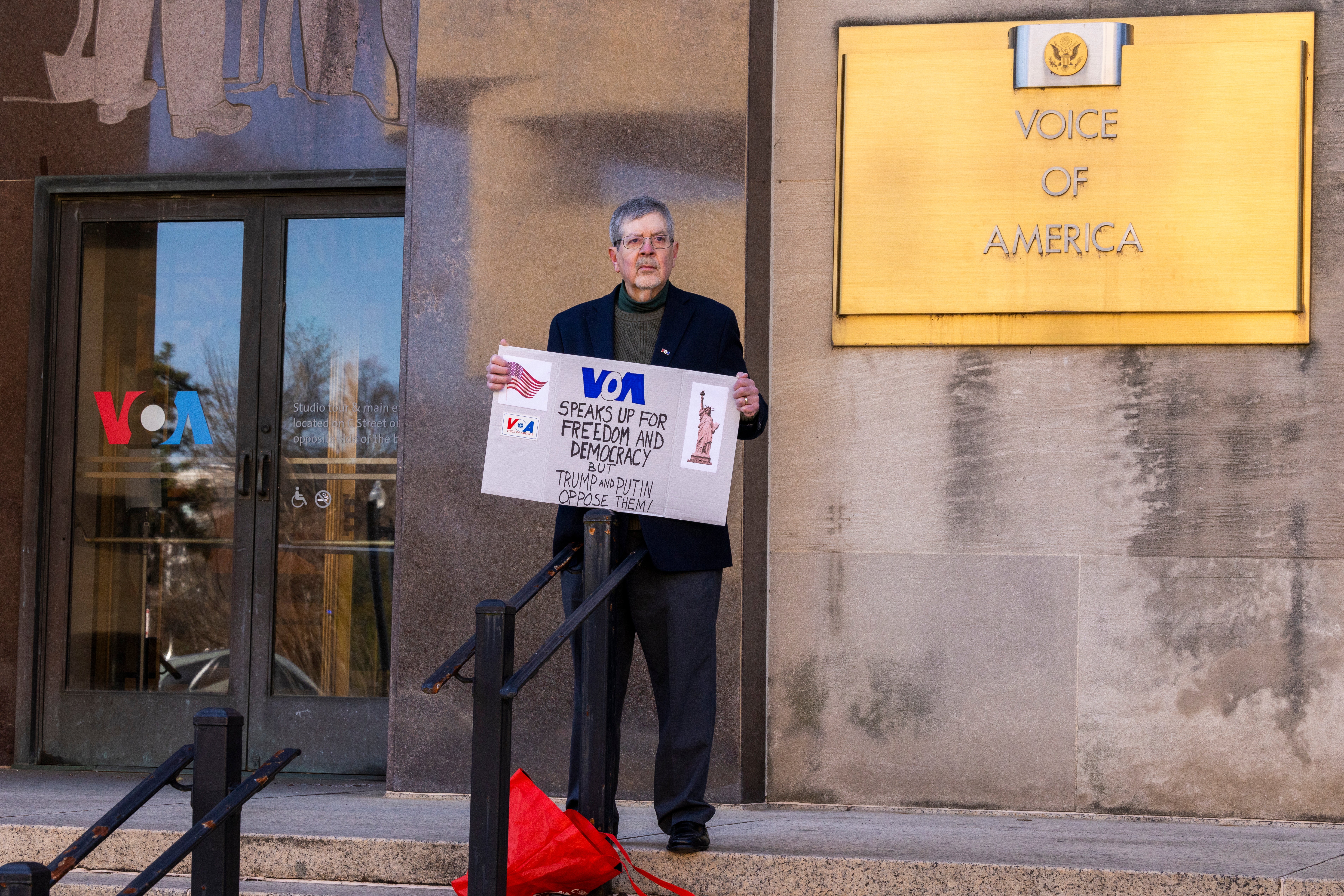 Steve Lodge, whose father Robert Lodge was a VOA correspondent, protests outside the media outlet’s headquarters in Washington