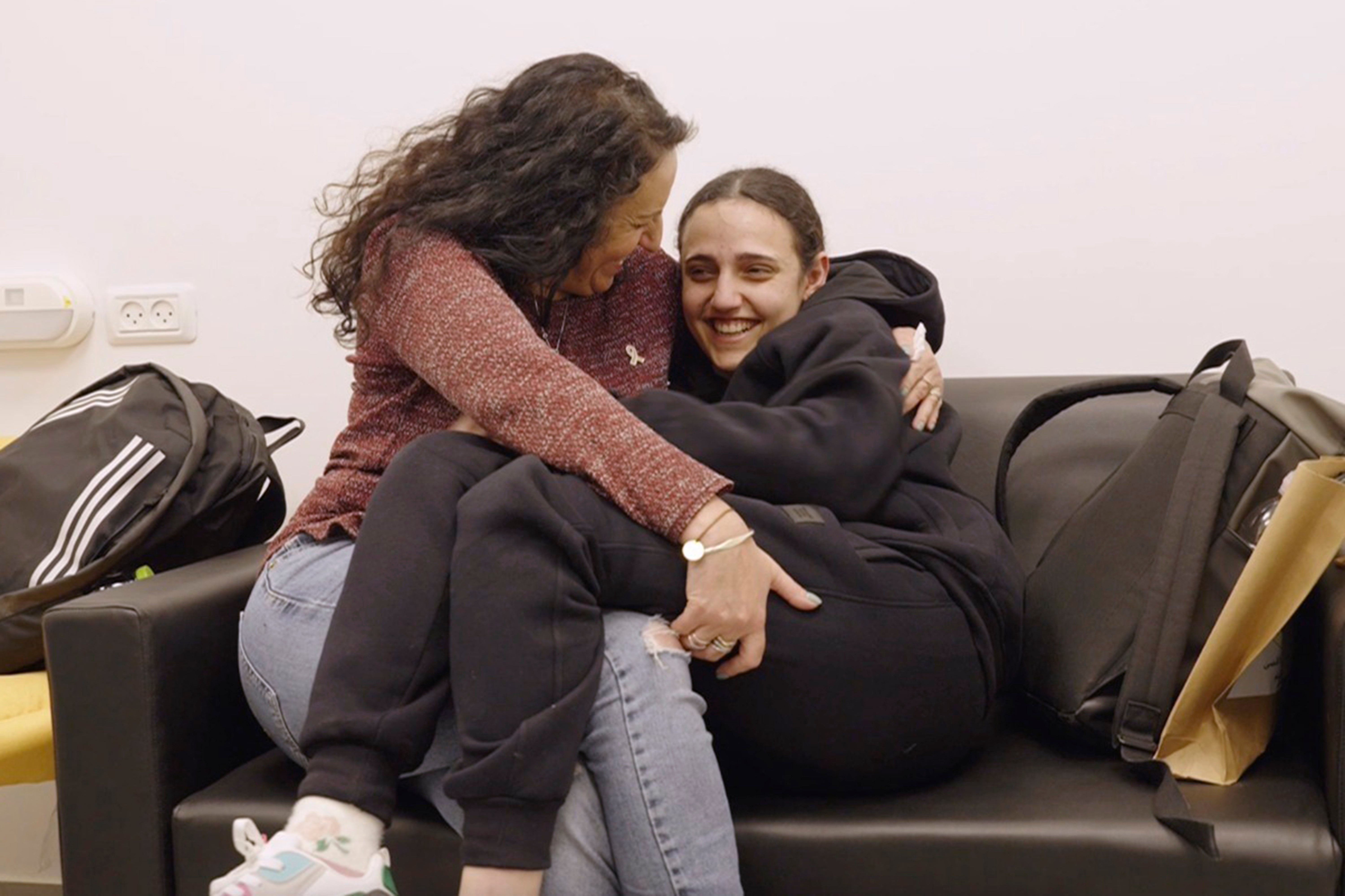 Romi Gonen, right, and her mother Merav hold each other near kibbutz Reim, southern Israel after Romi was released from captivity by Hamas militants in Gaza, 19 January 2025