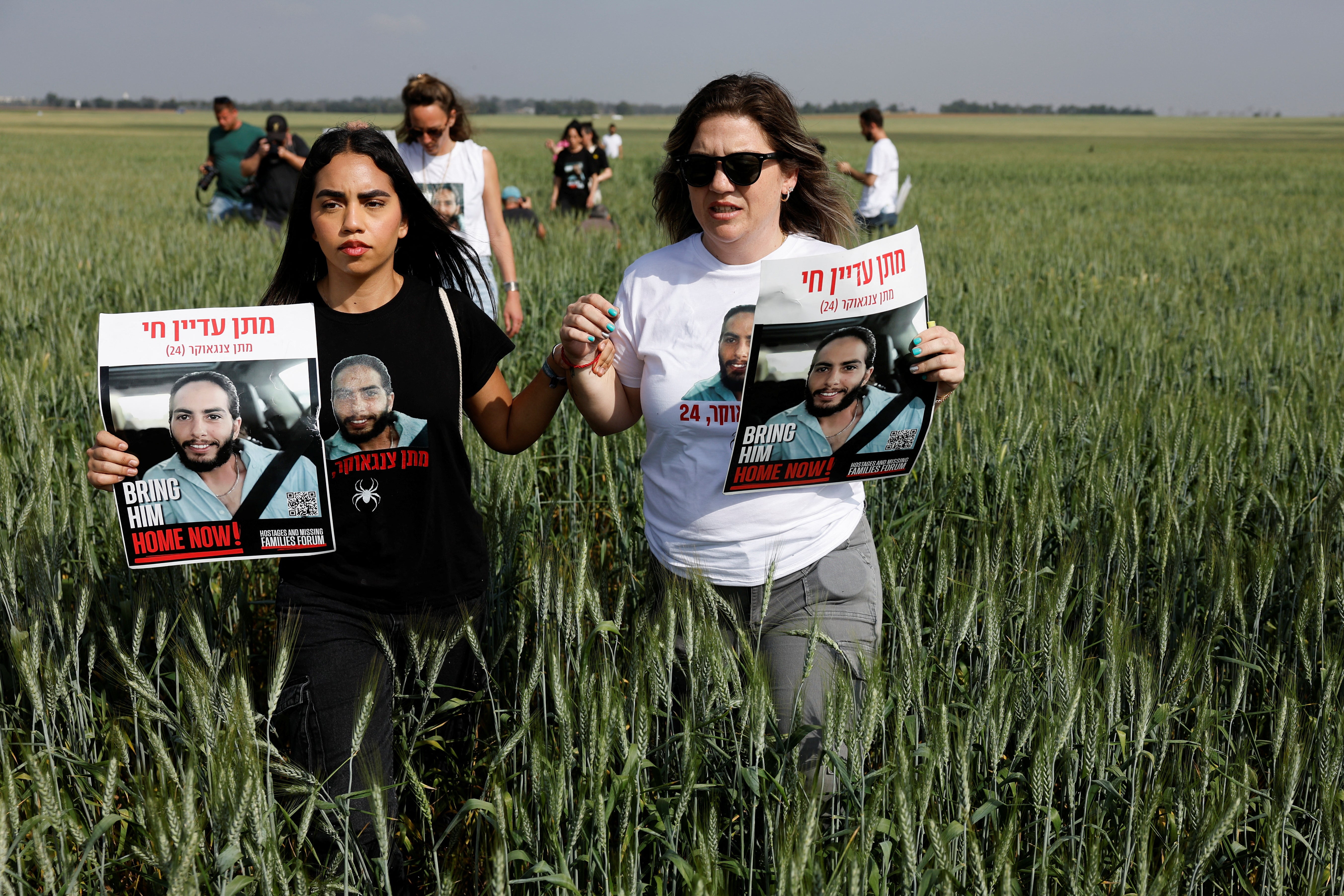 People hold posters with the picture of hostage Matan Zangauker, who was kidnapped during the deadly 7 October 2023 attack on Israel by Hamas