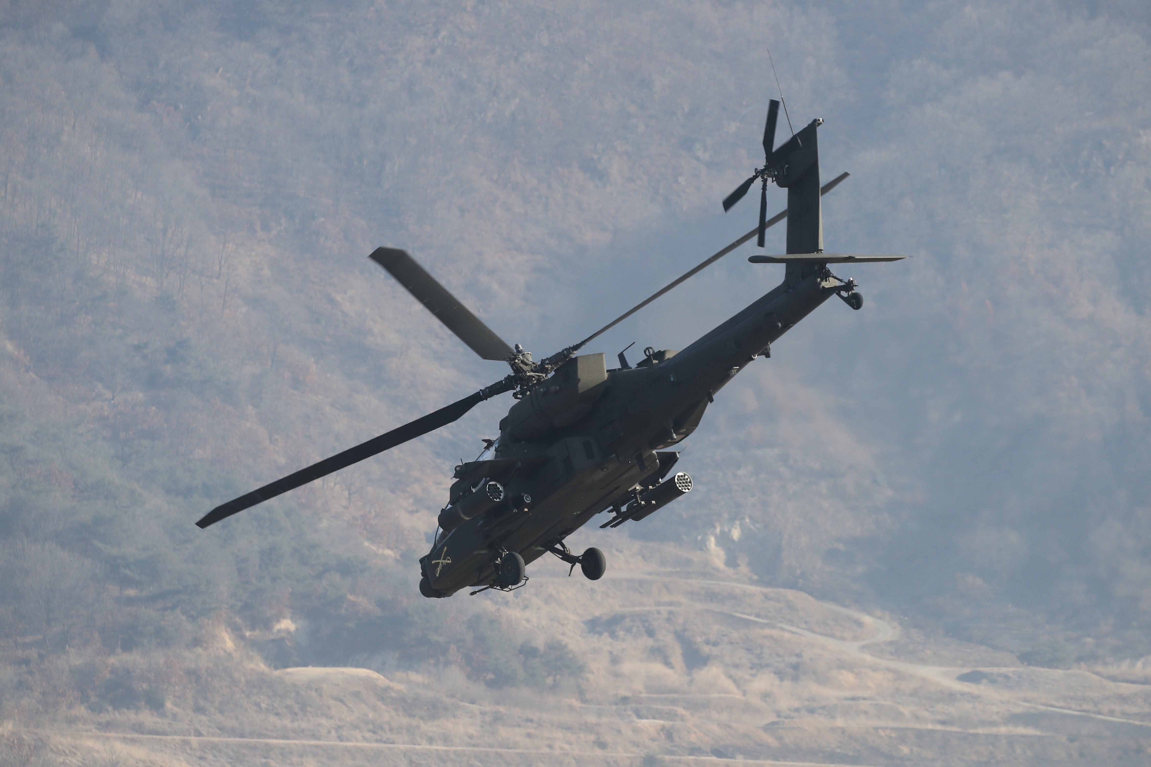 An American military helicopter hovers in the sky during a combined drill with South Korean soldiers from the 15th Infantry Division at the Rodriguez Live Fire Complex