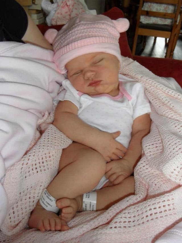 <p>Lucy, pictured as a baby, had a healthy birth and developed normally until 18 months old</p>