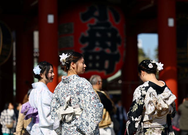 <p>Tourists wearing Japanese traditional kimono clothes stroll near Sensoji temple at Asakusa district</p>