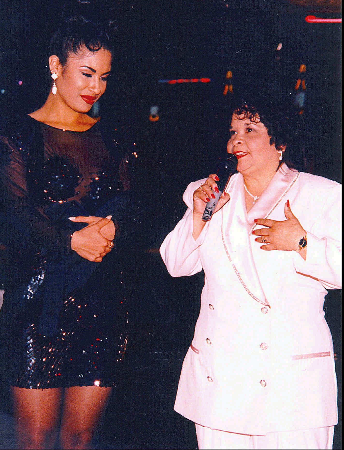 Tejano star Selena, left, watches as Yolanda Saldívar speaks to a crowd at a post-1994 Tejano Music Awards party in San Antonio, Texas. Saldívar shot Selena to death in a Corpus Christi motel room Friday, March 31, 1995