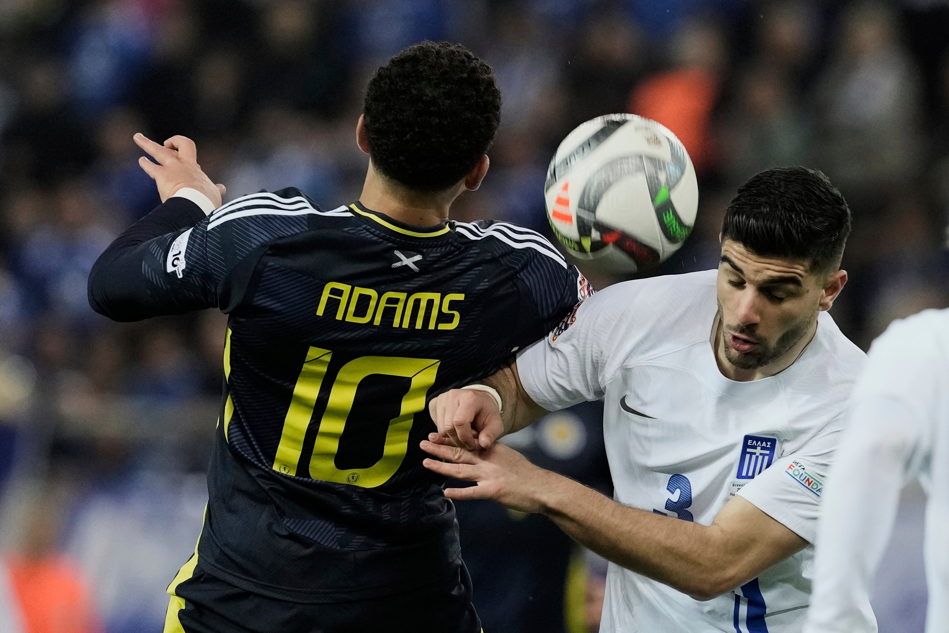 Che Adams goes for the ball in a difficult second half for Scotland