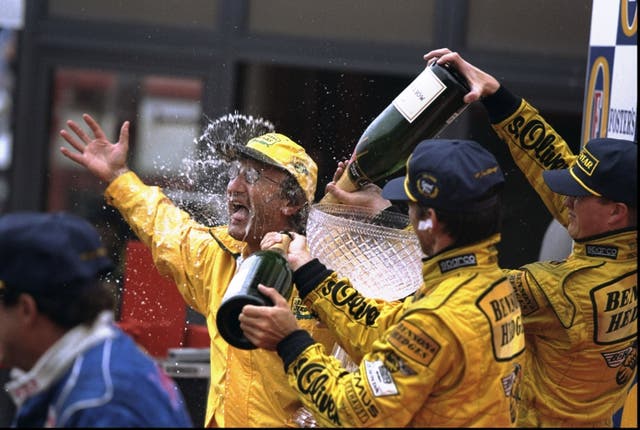 <p>Eddie Jordan is doused in Champagne by his drivers</p>