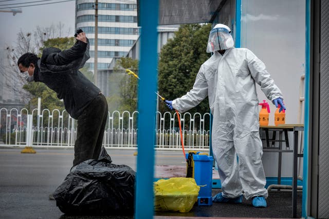 <p>File: A who has recovered from the Covid-19 infection being disinfected by a medical staff before leaving the hospital in Wuhan in China's central Hubei province</p>