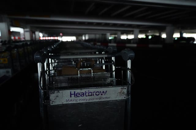 Trollies in the unlit car park at Heathrow terminal four in London (James Manning/PA)